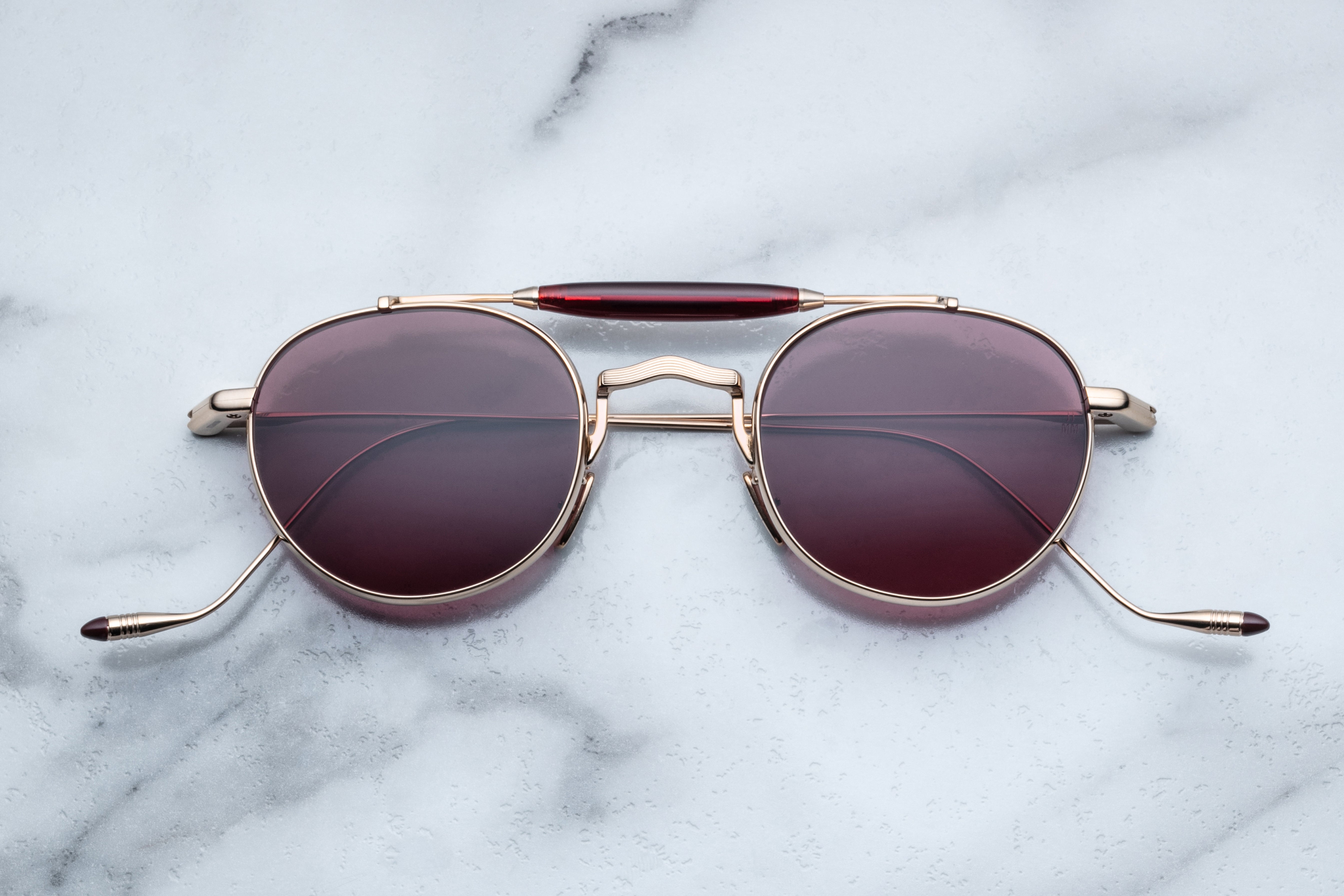 Jacques Marie Mage Dasan sunglasses with champagne-colored frames and clear lenses, front view showing stylish design.