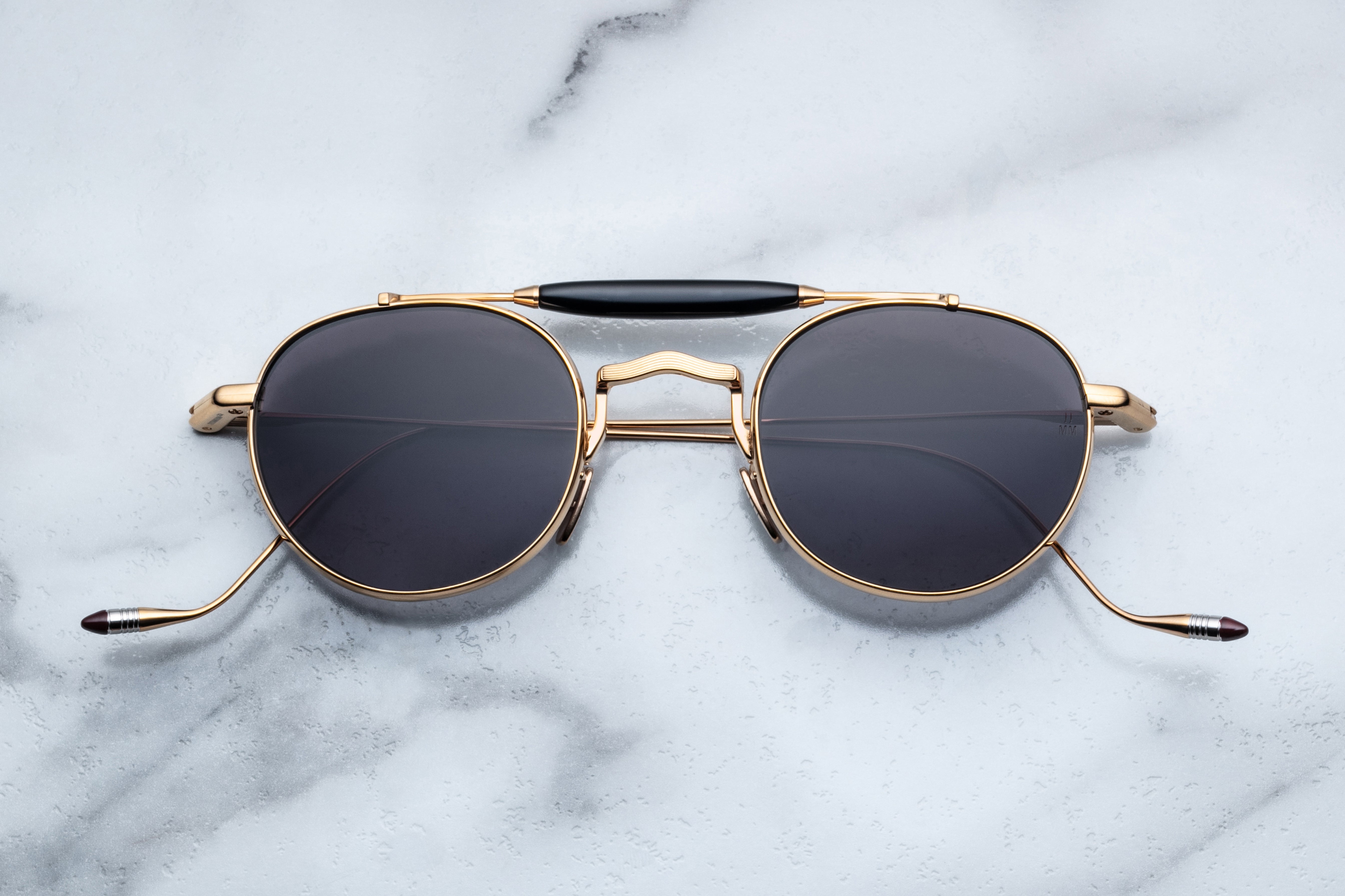 Jacques Marie Mage Dasan gold sunglasses with sleek front view, showcasing stylish frames and tinted lenses.