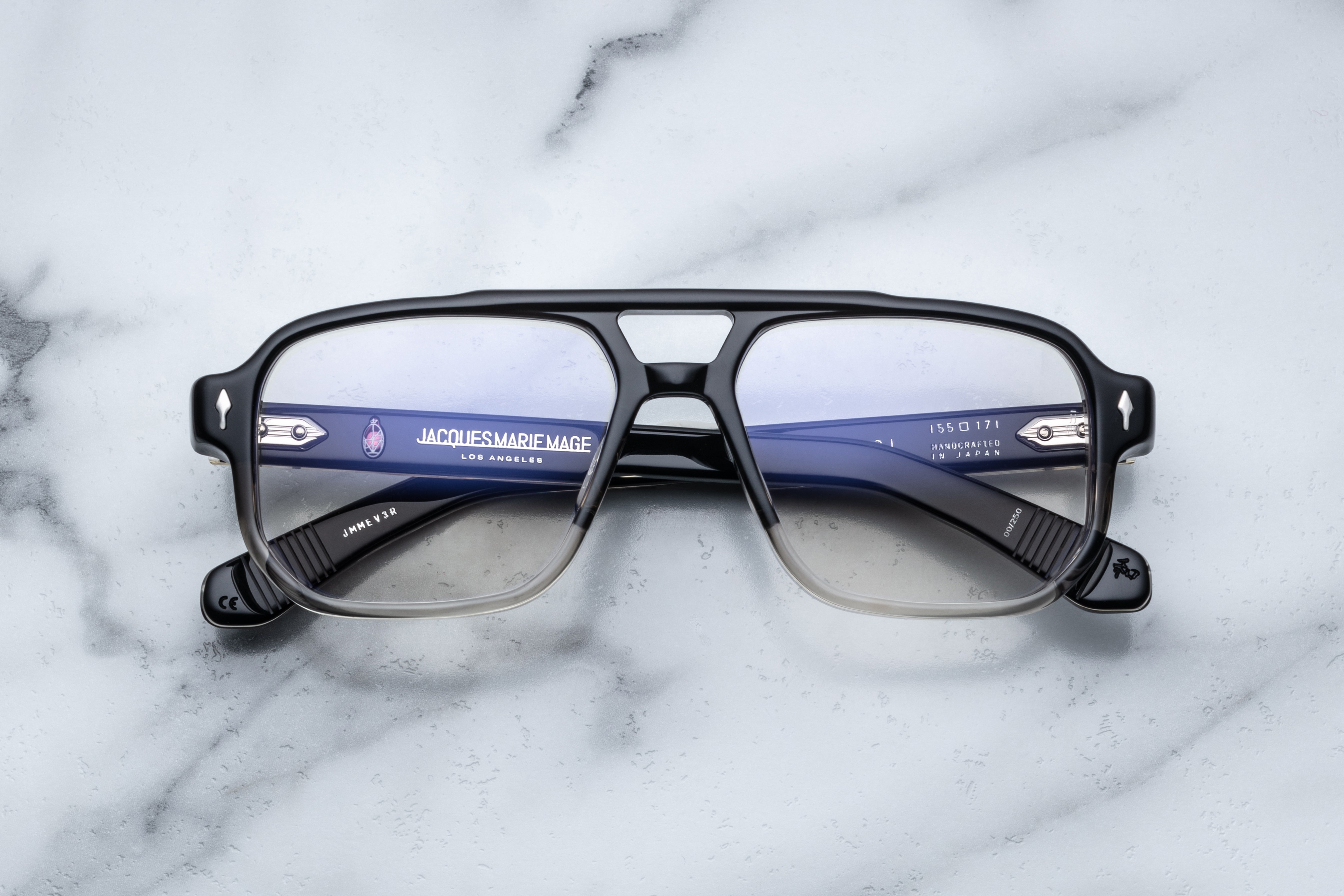 Jacques Marie Mage Evans RX optical glasses in black fade finish, front view showing sleek rectangular frames and clear lenses.