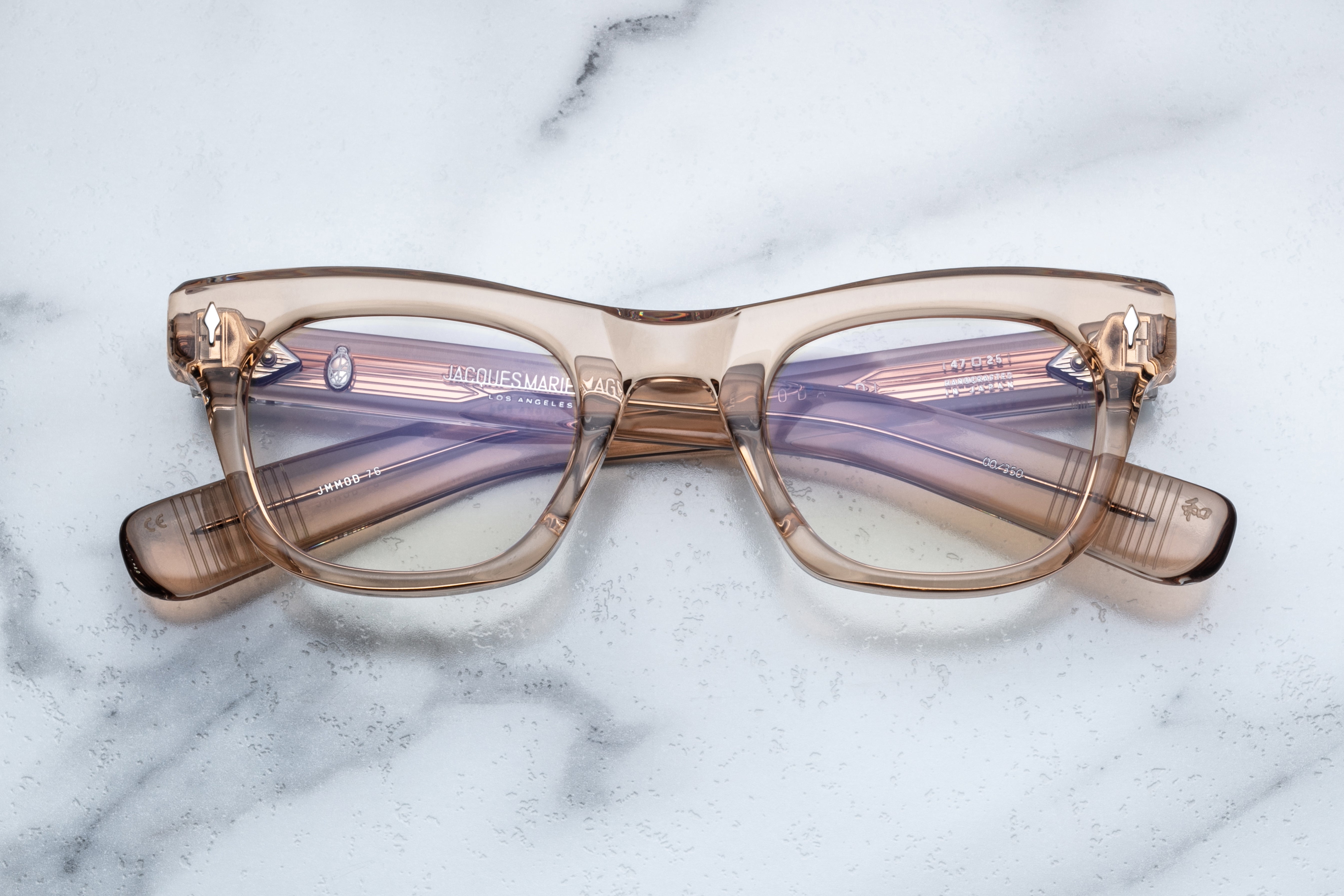 Jacques Marie Mage Godard optical eyewear with clear lenses and sleek design, shown from the front.