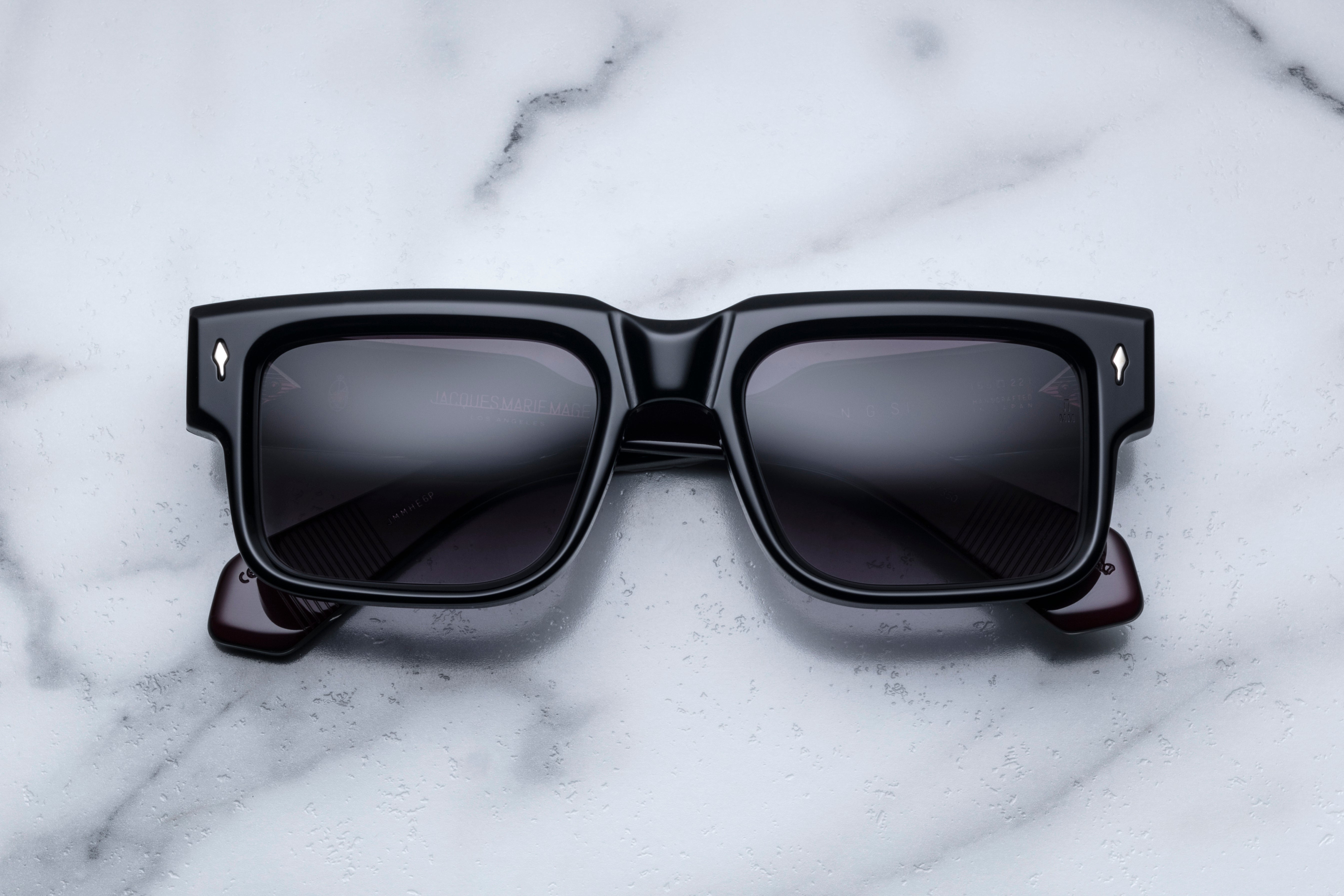 Jacques Marie Mage Hemmings Bloodstone sunglasses with round frame and dark tinted lenses, front view showing stylish design.