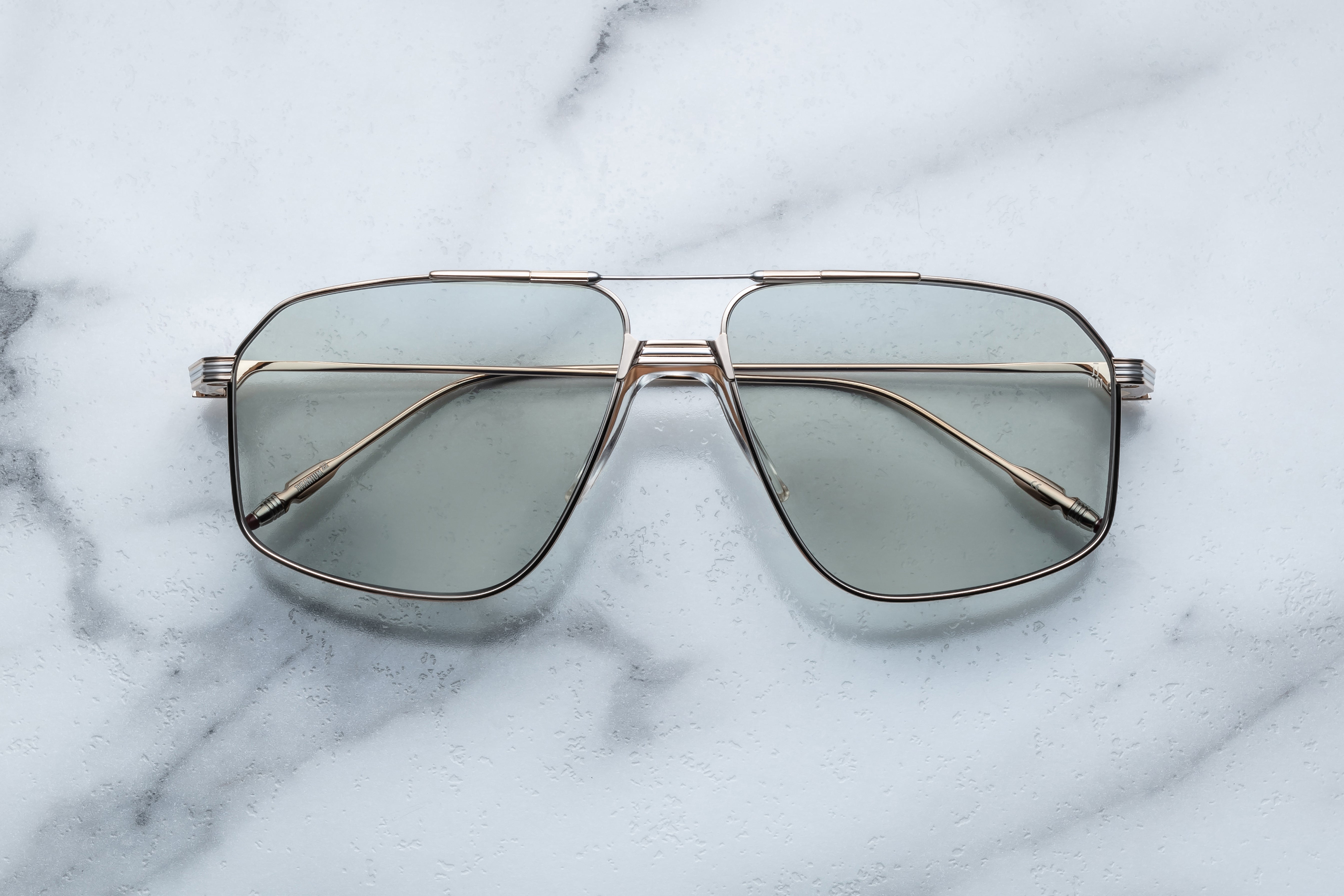 Jacques Marie Mage JAGGER sunglasses with gold metal frames and tinted lenses, front view showing sleek, modern design.