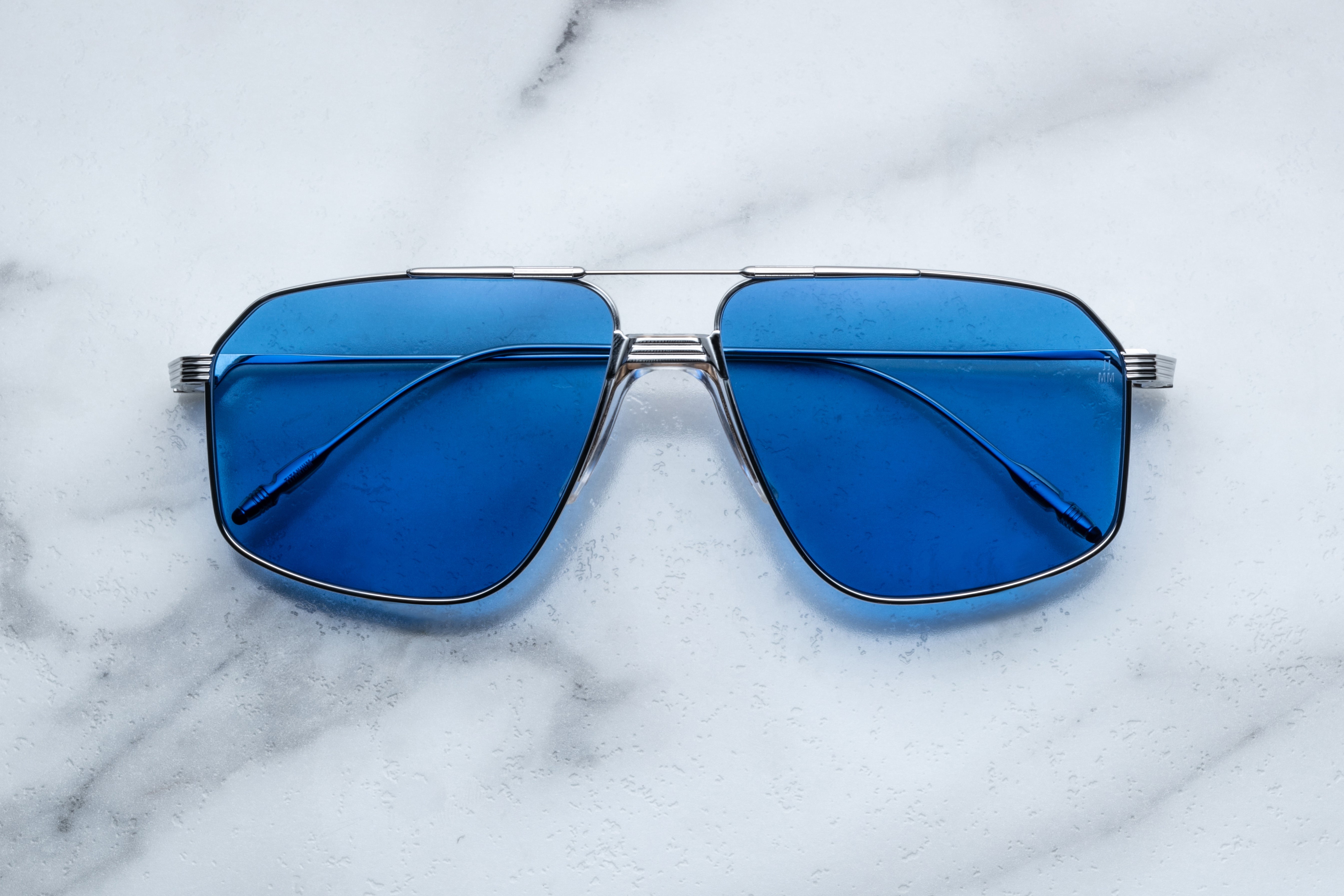 Jacques Marie Mage JAGGER sunglasses with blue-tinted lenses and sleek black frame, shown from the front.