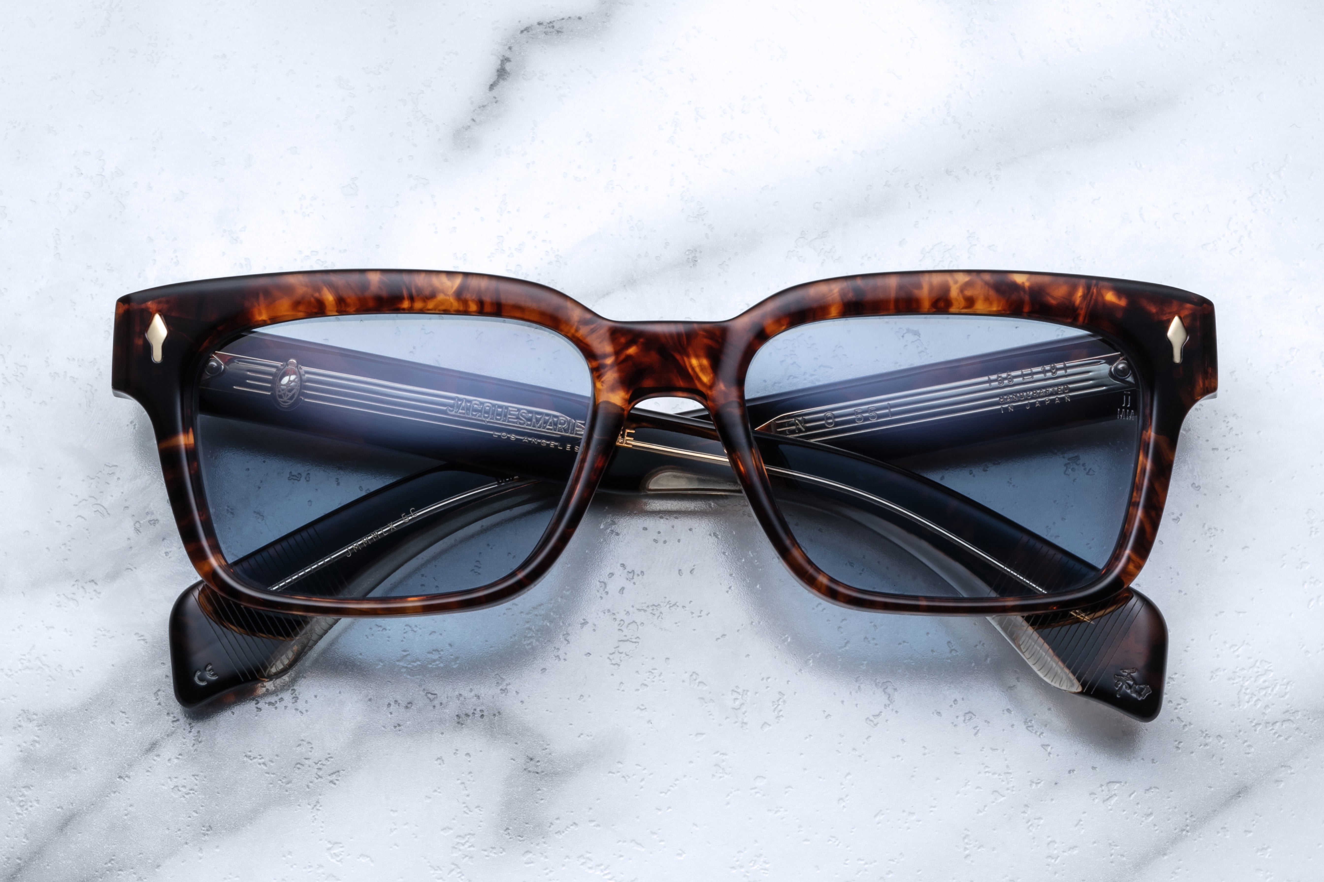 Jacques Marie Mage Molino 55 sunglasses with argyle patterned frames and clear lenses, front view showing stylish design.