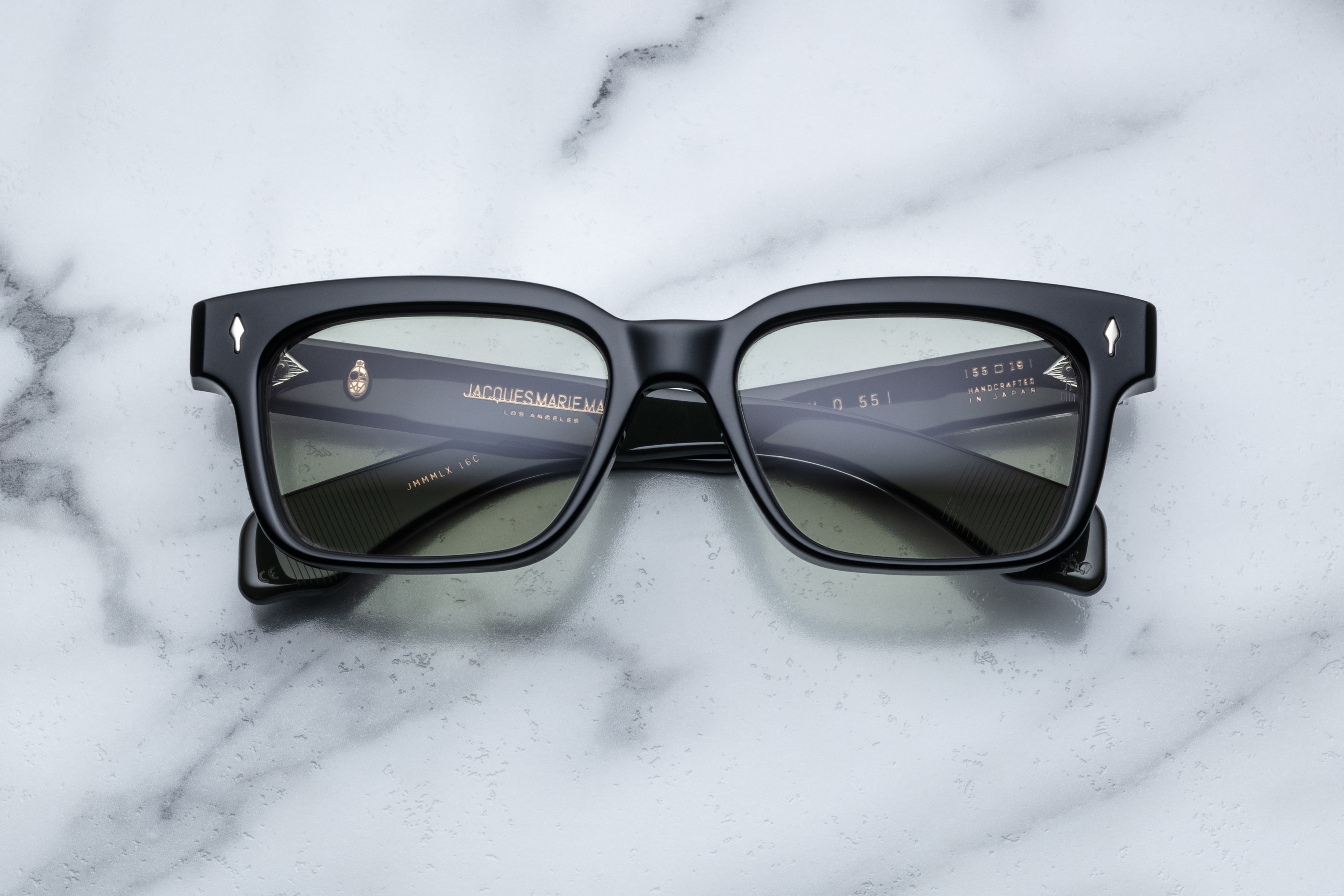 Jacques Marie Mage Molino 55 sunglasses with cobra-embossed frames, front view showing dark tinted lenses and stylish design.