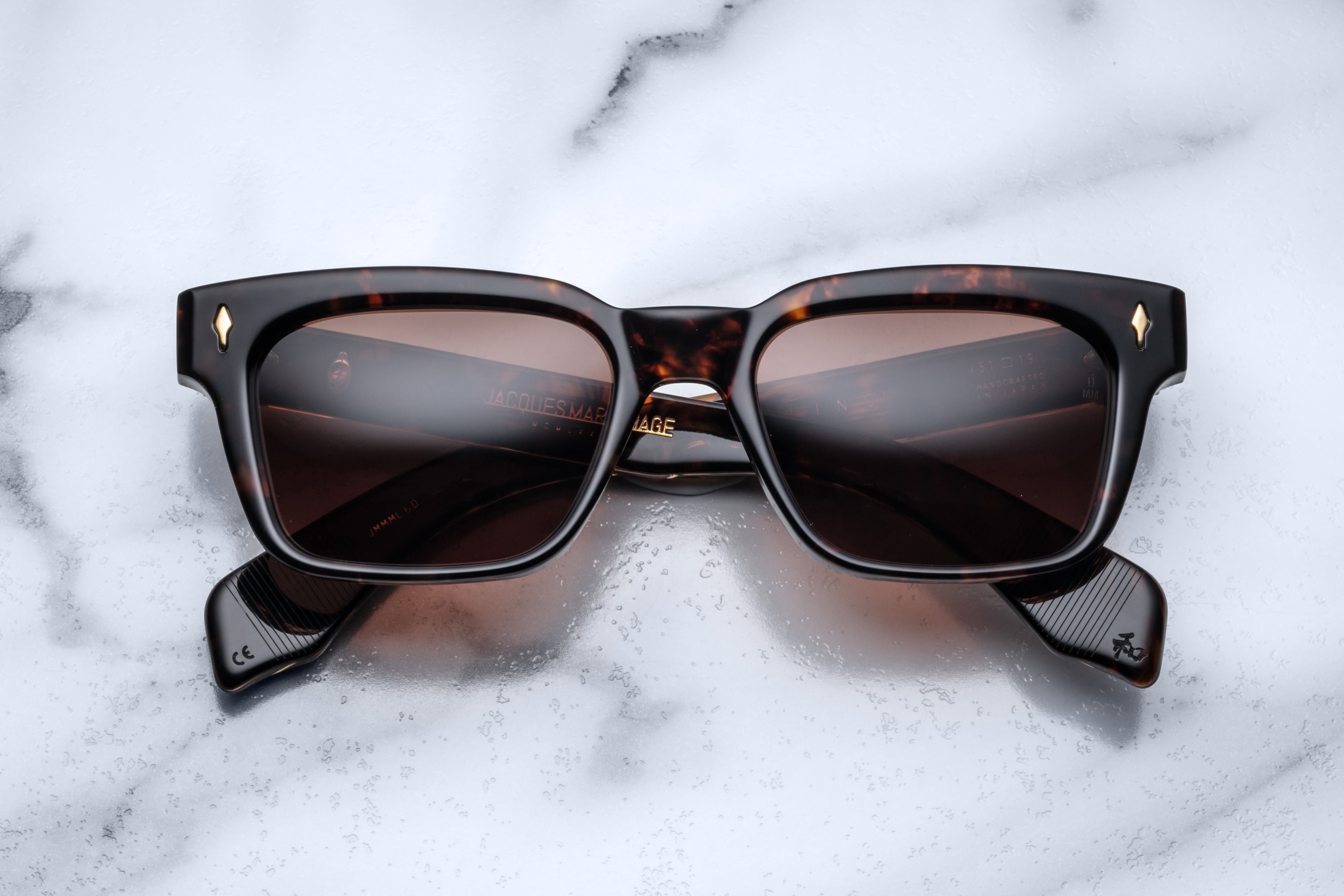 Jacques Marie Mage Molino sunglasses with tortoiseshell frames and dark lenses, front view showing stylish eyewear design.