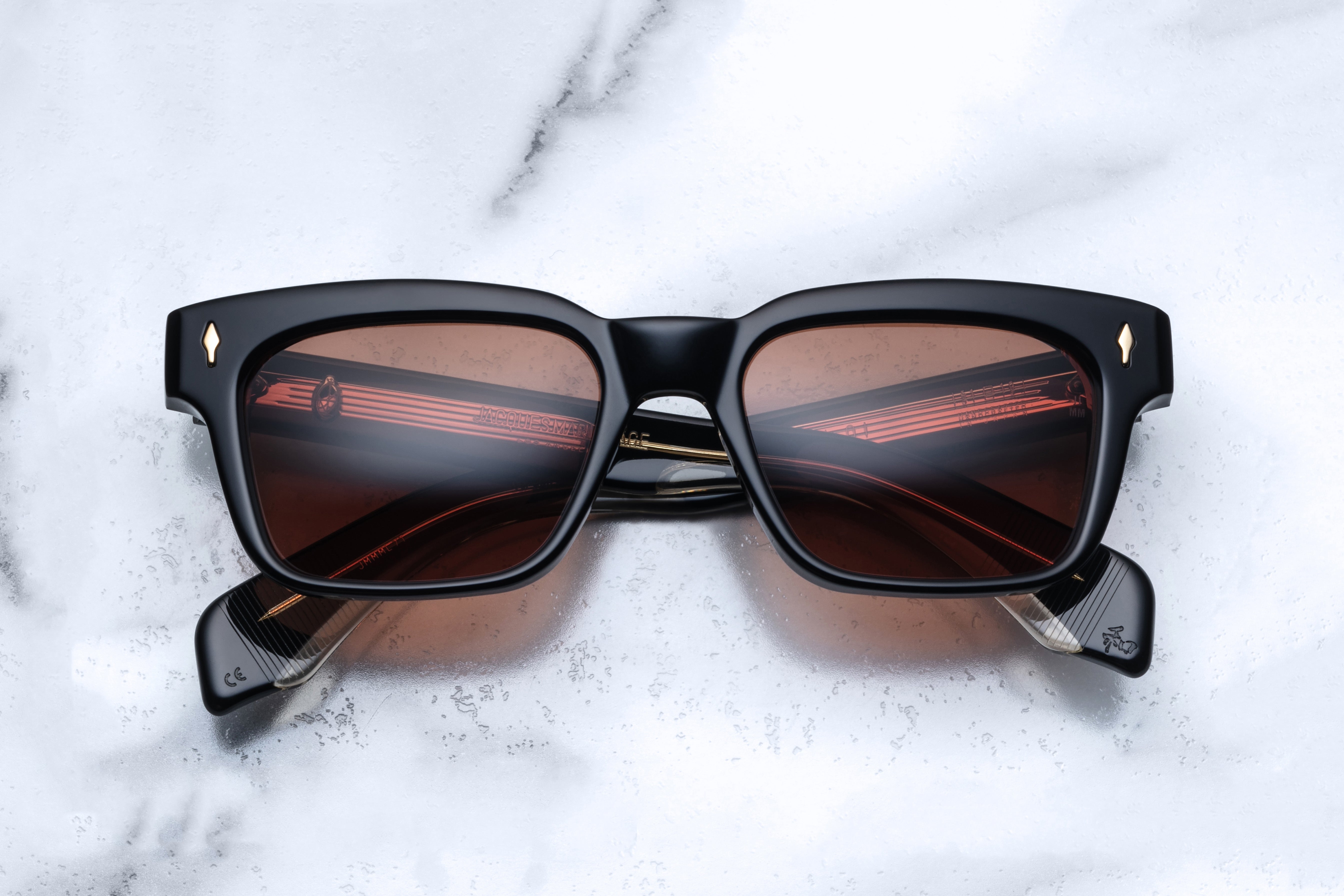 Jacques Marie Mage Molino Beluga sunglasses with clear front lenses and dark frames, showcasing sleek, modern eyewear design
