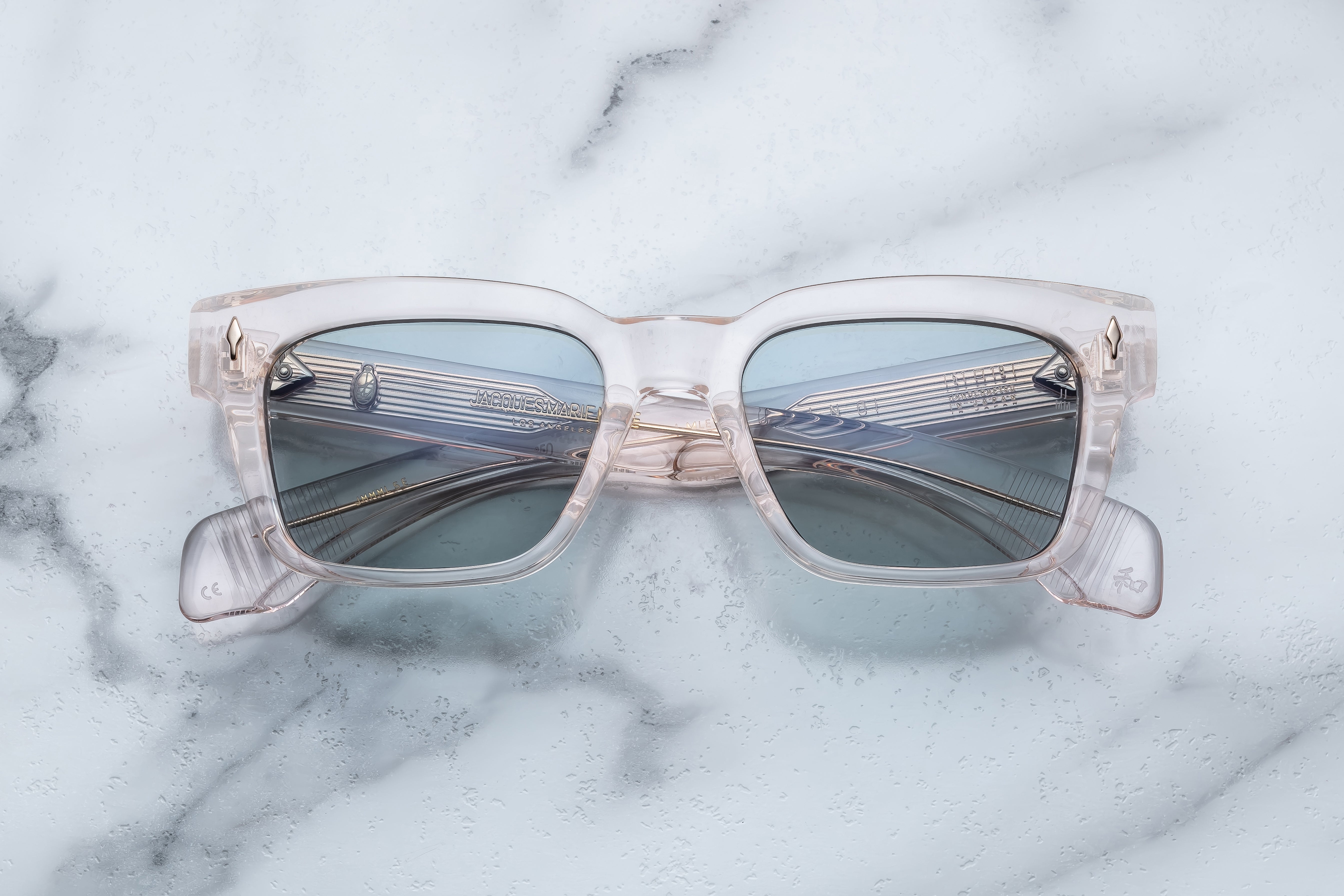 Jacques Marie Mage Molino sunglasses with cameo-colored frame and clear lenses, close-up front view.