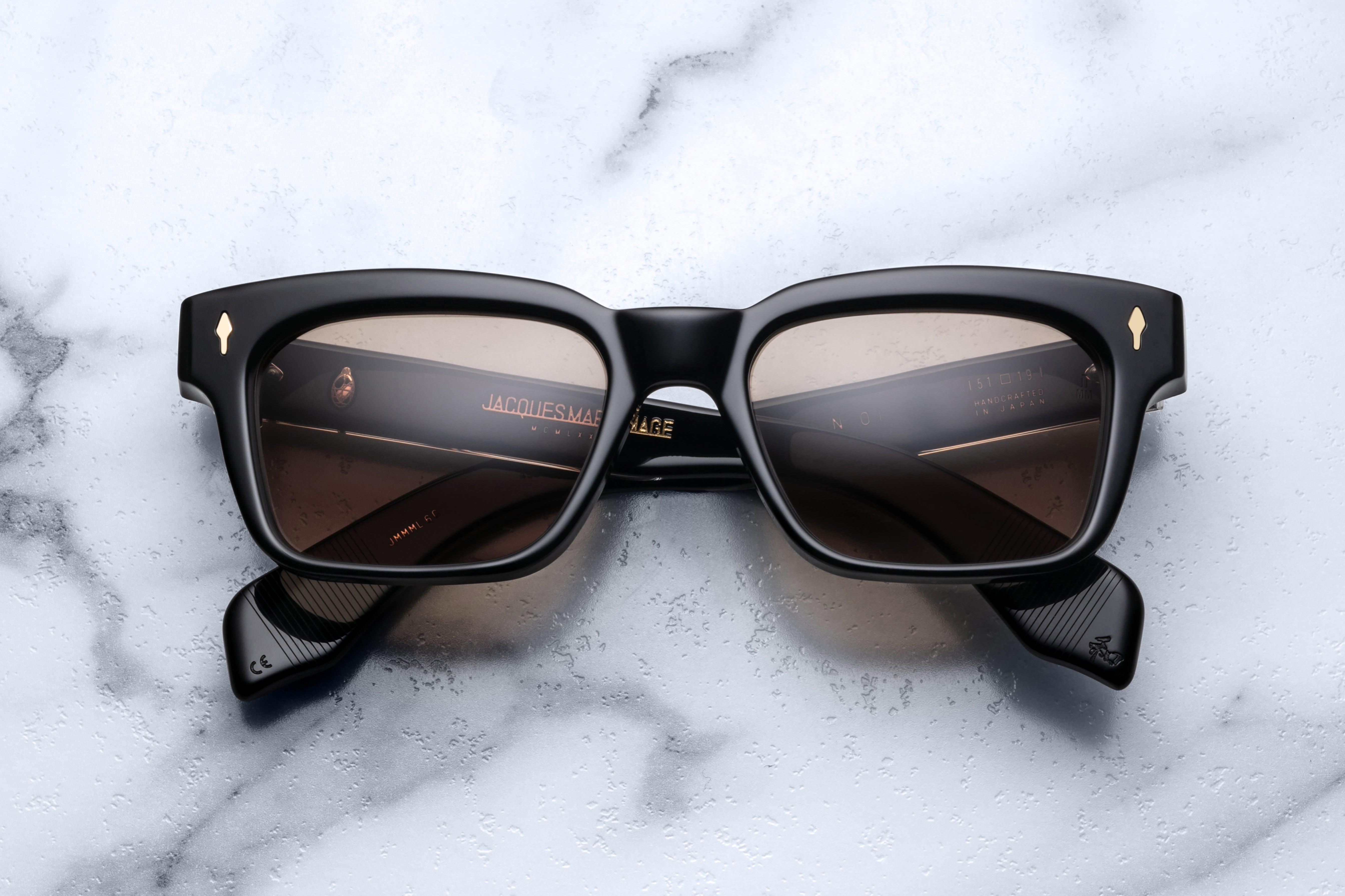 Jacques Marie Mage Molino Eclipse sunglasses with dark tinted lenses and sleek black frame, front view.