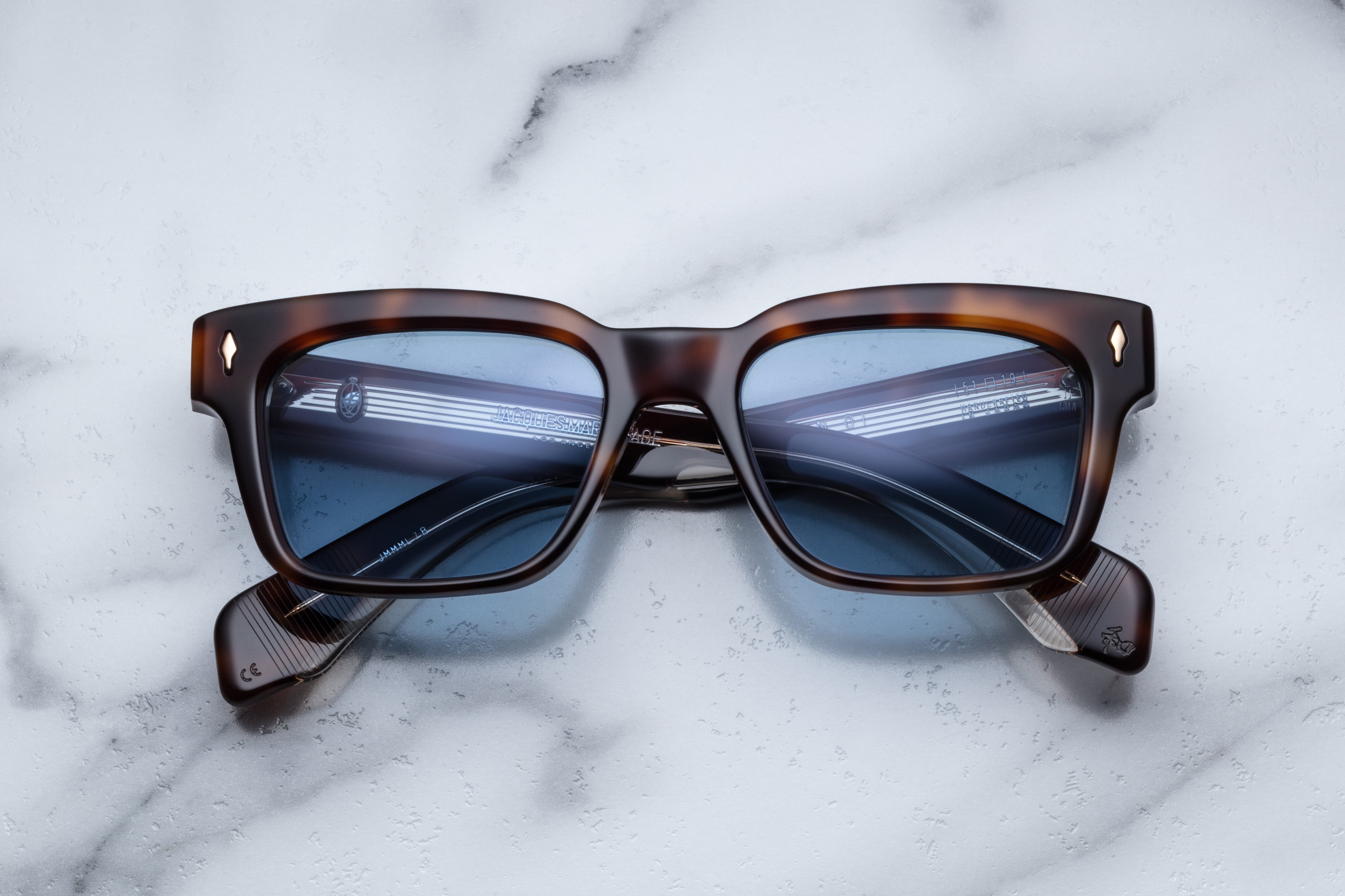 Jacques Marie Mage Molino Havana sunglasses with rounded frames and dark tinted lenses, displayed from the front view.