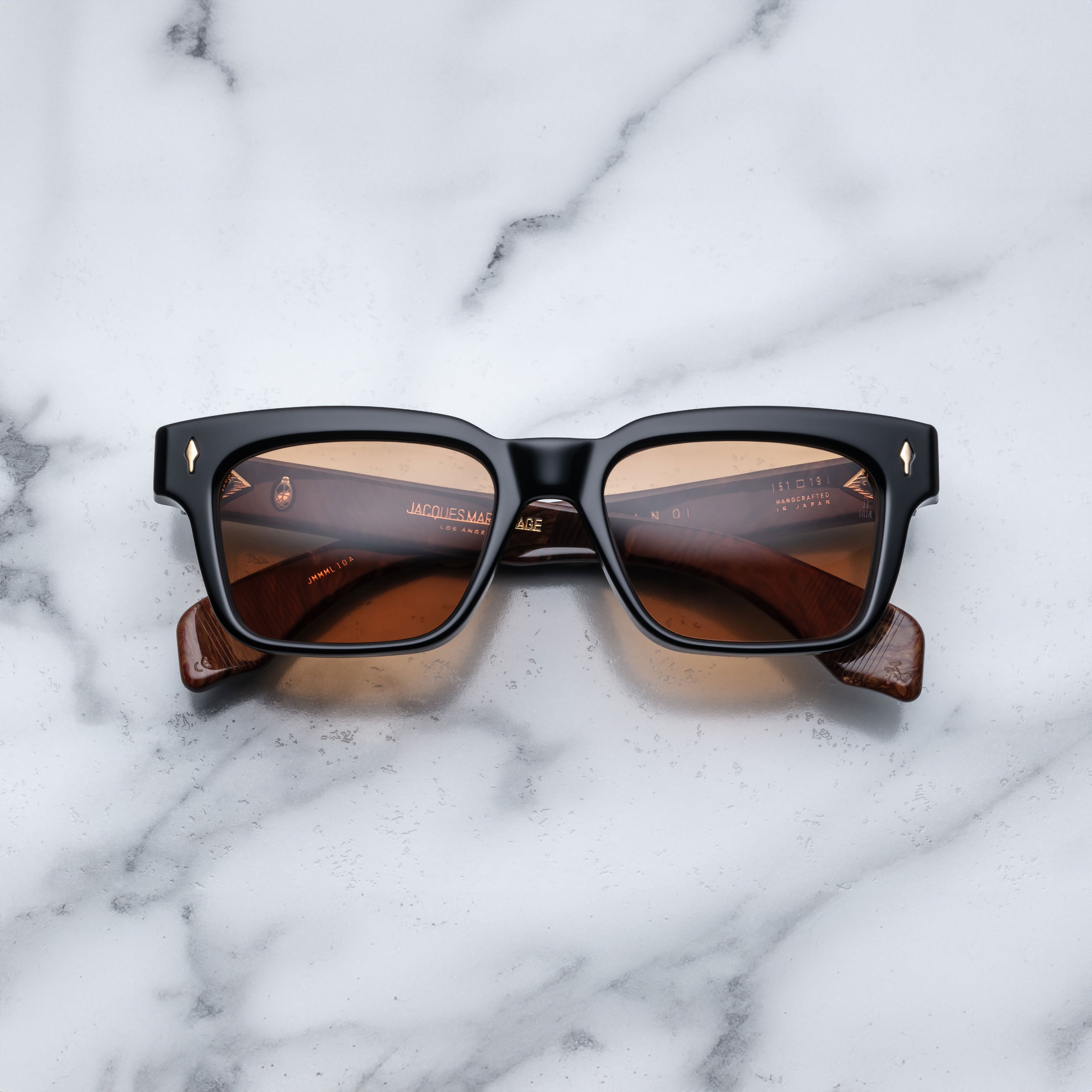 Jacques Marie Mage Molino Noir sunglasses with rounded black frames and clear lenses, shown from the front.