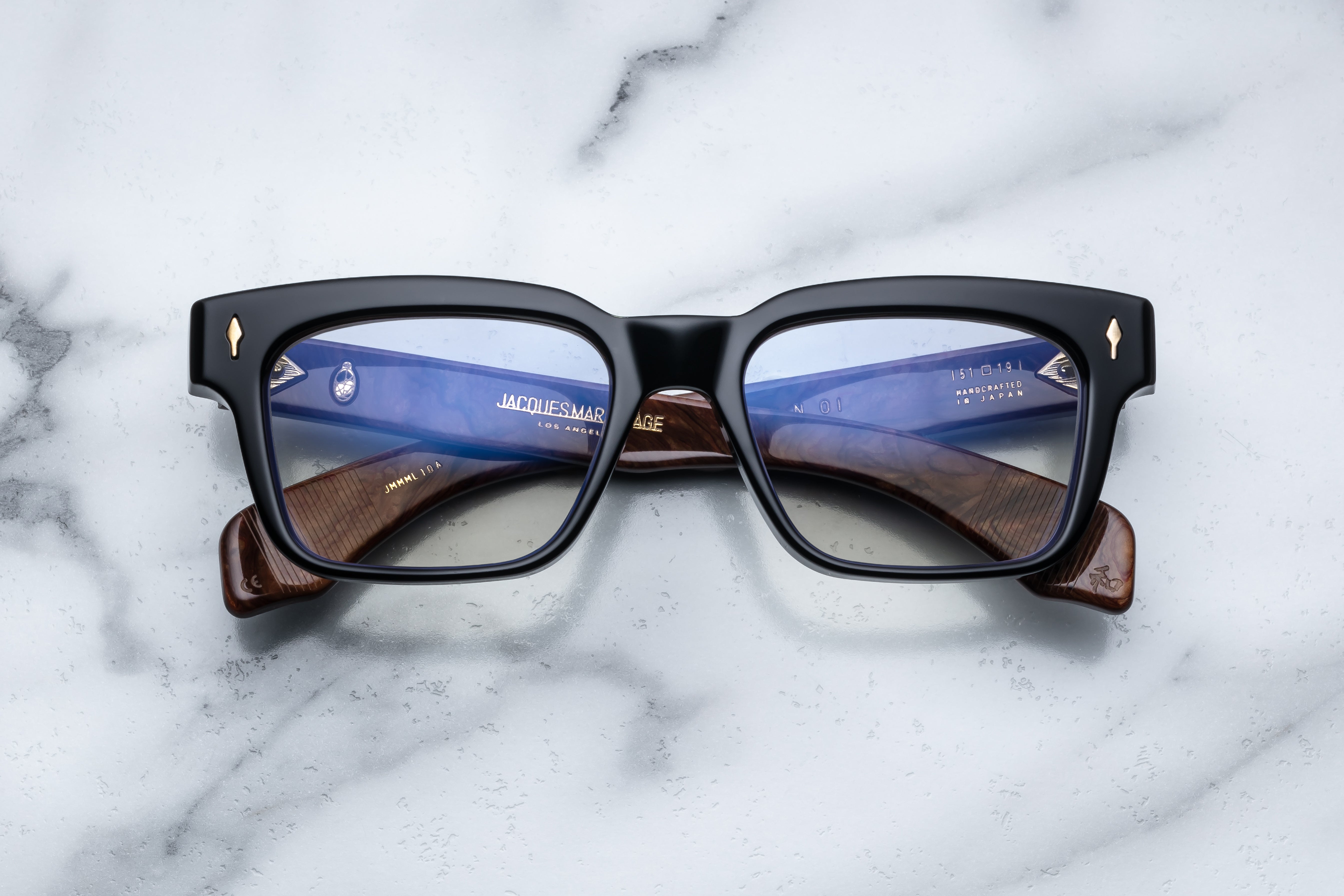 Jacques Marie Mage Molino Noir RX sunglasses with black frame and clear lenses, front view showing sleek design and stylish details.