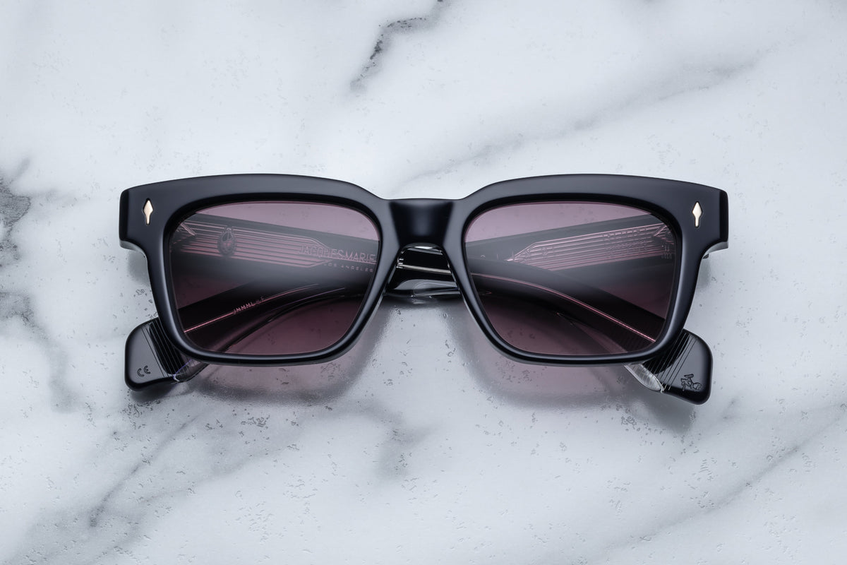 Jacques Marie Mage Molino sunglasses with a sleek front view, featuring black frames and tinted lenses.