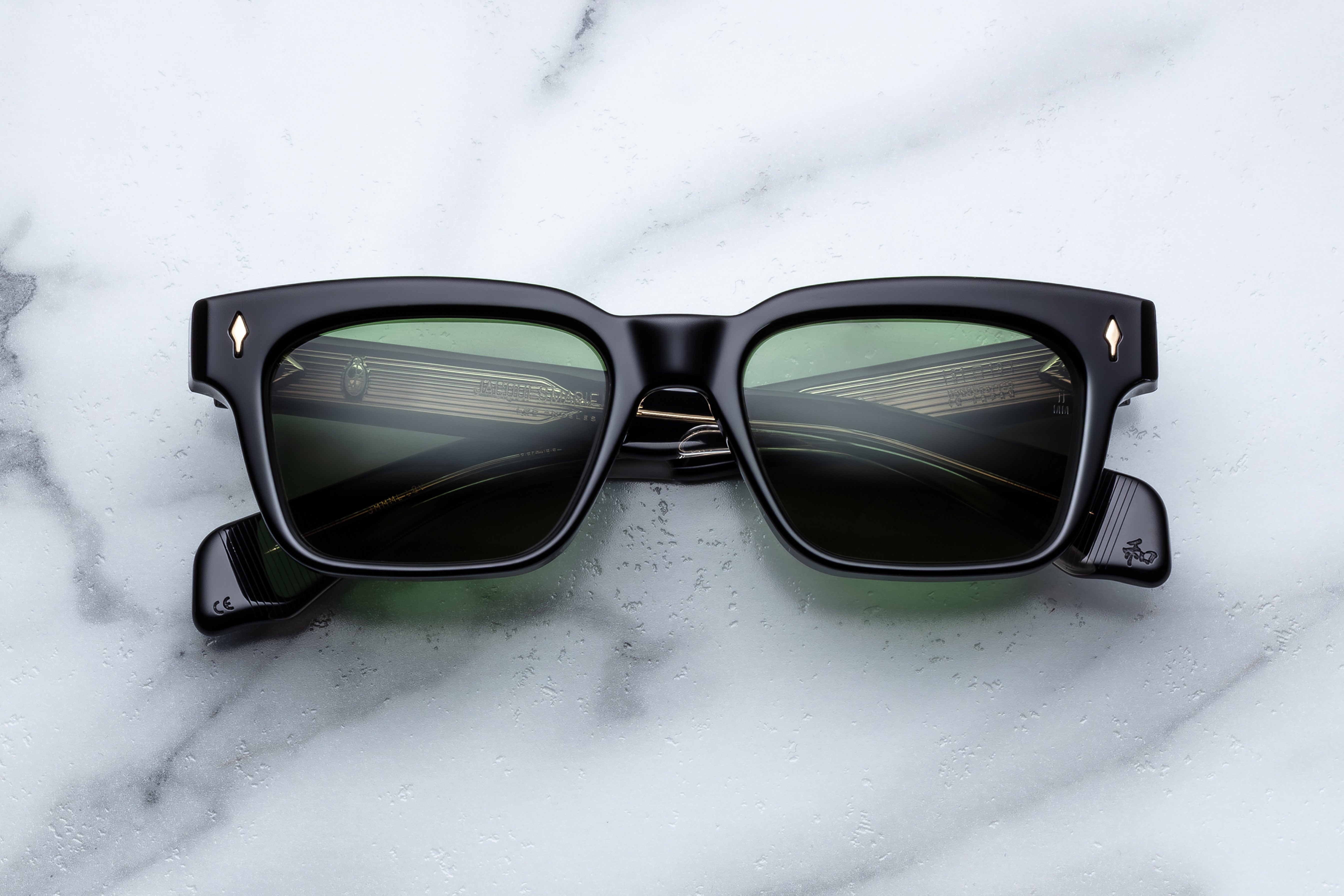Jacques Marie Mage Molino sunglasses with sleek black frames and tinted lenses, front view showing stylish design.
