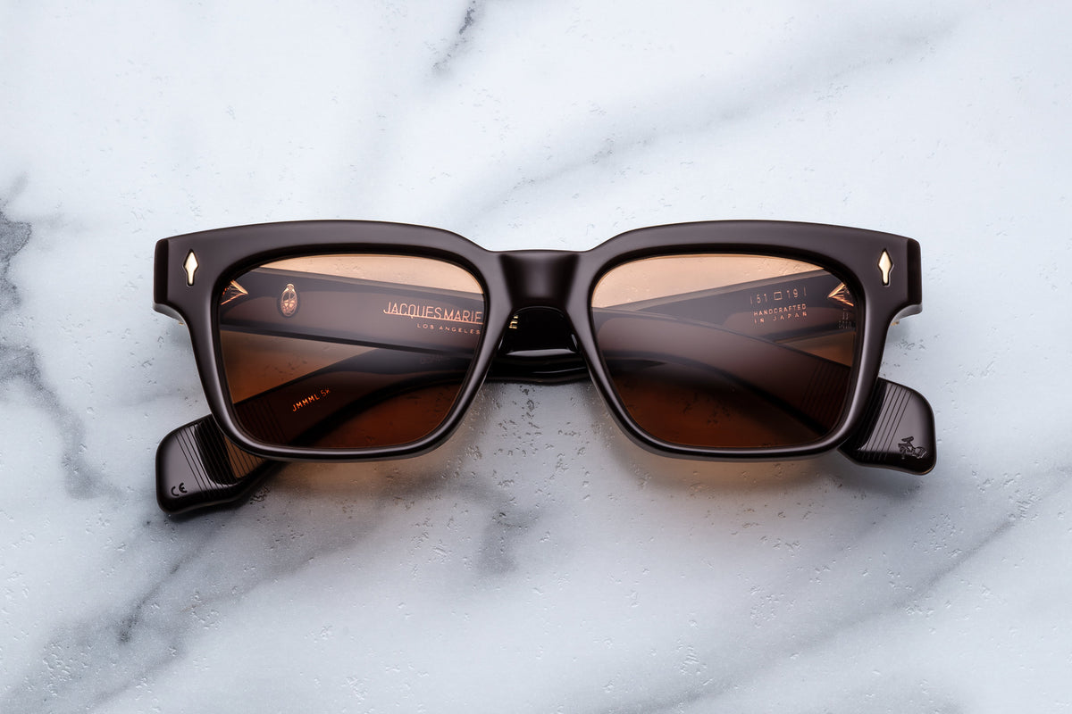 Jacques Marie Mage Molino sunglasses with walnut frame and clear lenses, front view showcasing stylish and modern eyewear design.