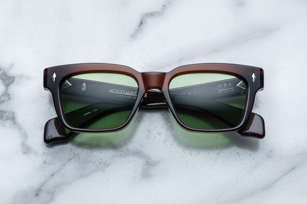 Jacques Marie Mage Molino sunglasses with clear frame and dark tinted lenses, front view showing sleek design.
