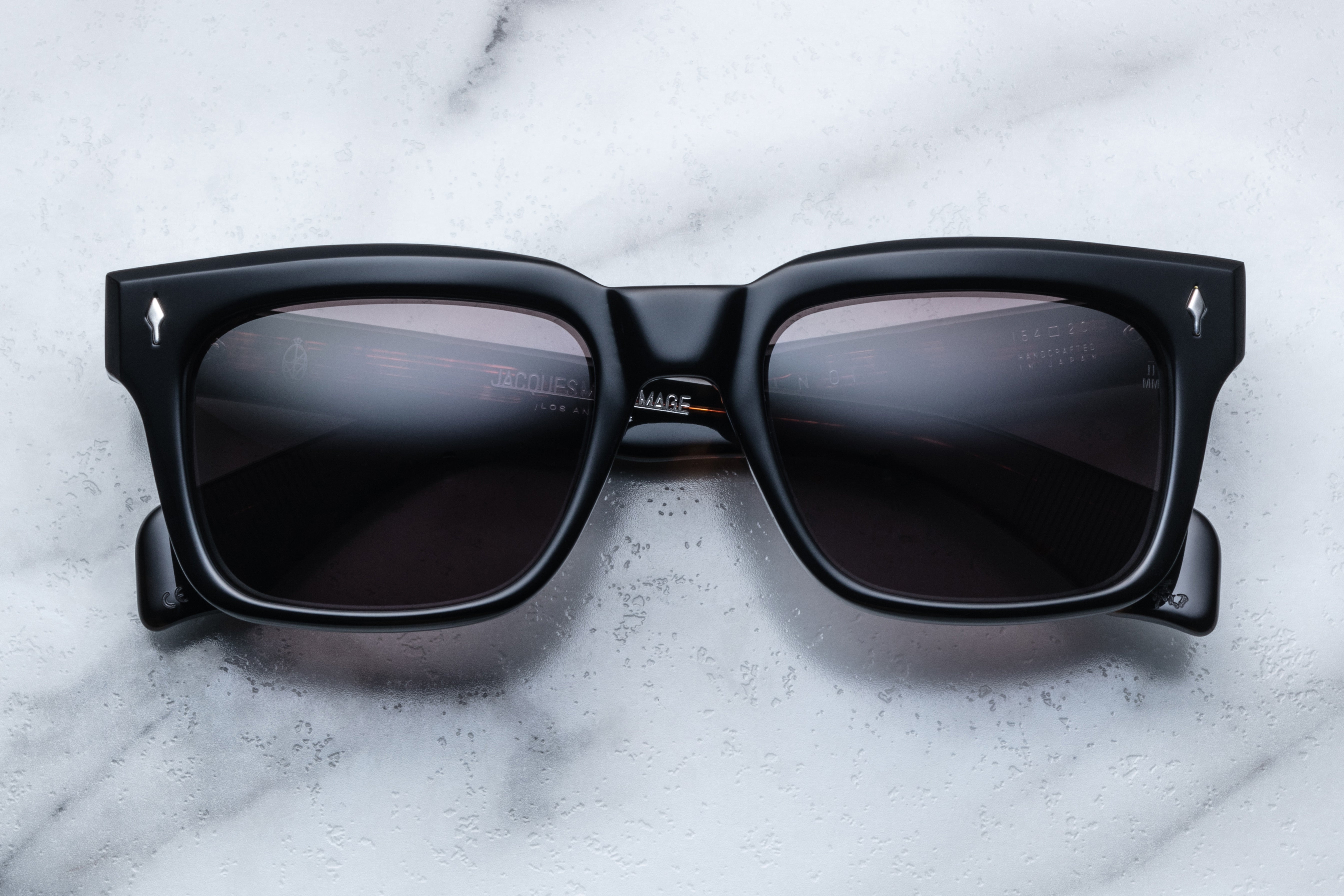Jacques Marie Mage Torino Noir sunglasses with black frames and clear lenses, front view showing sleek, modern design.