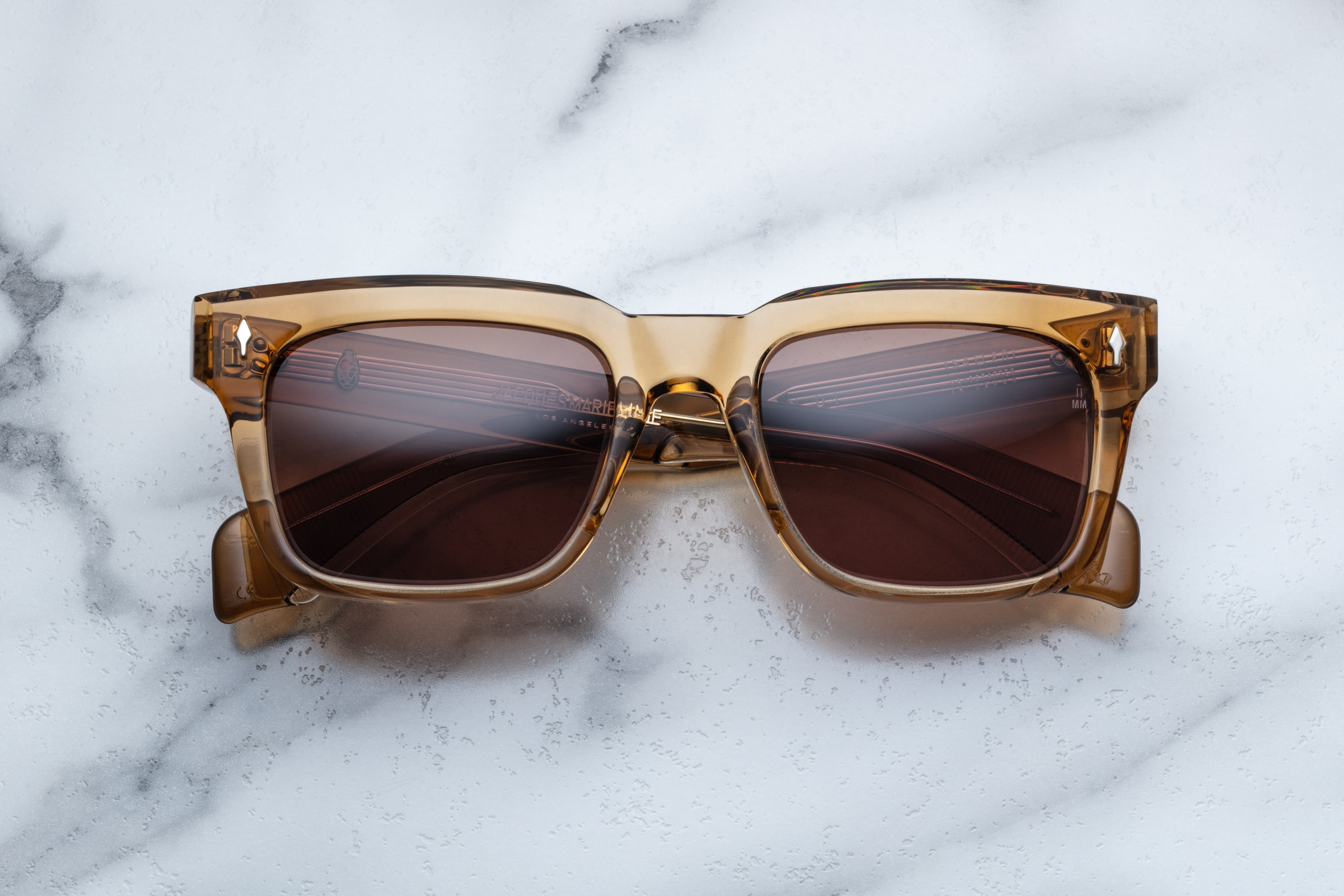 Jacques Marie Mage Torino sunglasses with ocre-colored frames and clear lenses, front view showing stylish eyewear design.
