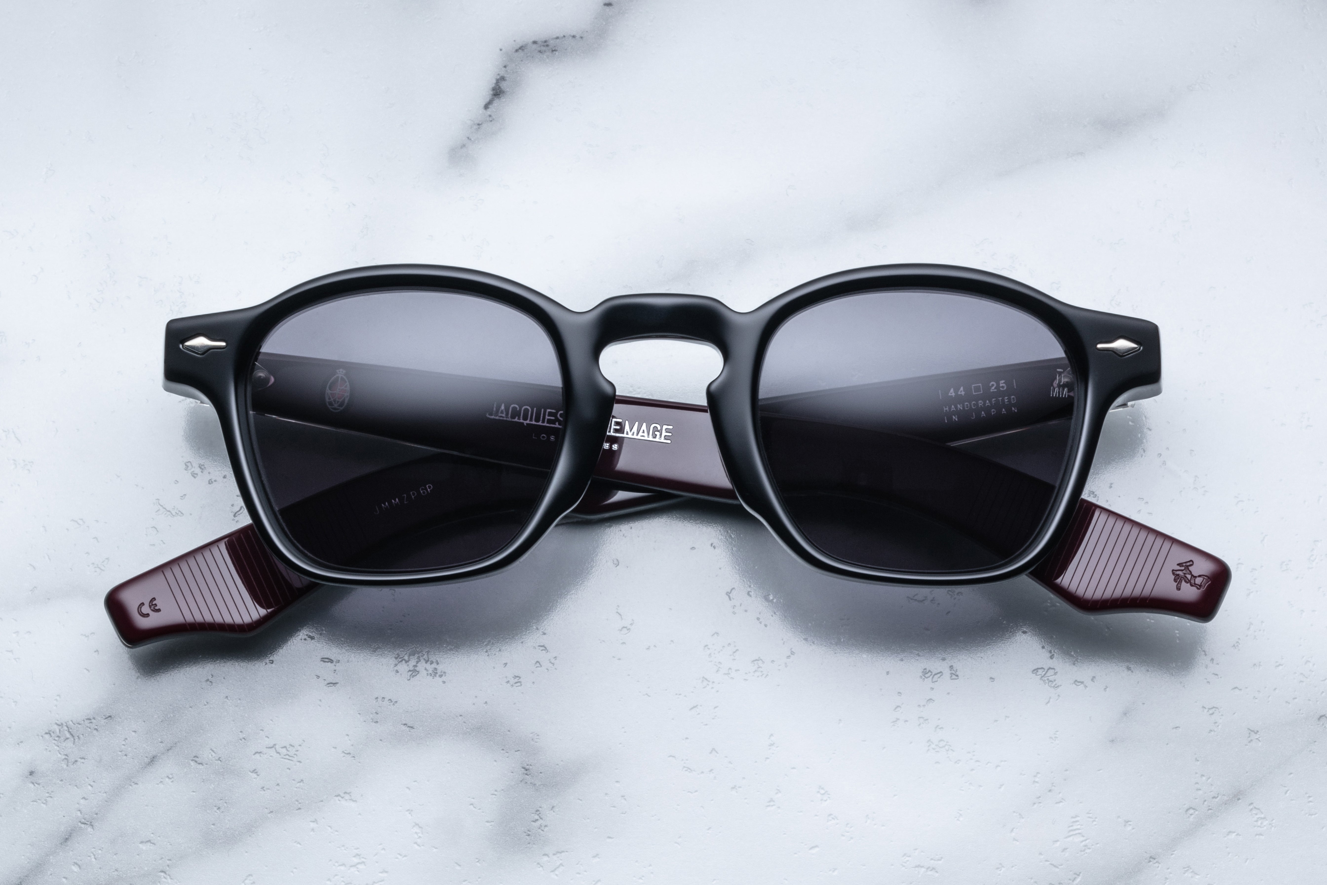 Jacques Marie Mage Zephirin Bloodstone sunglasses with rounded frames and dark tinted lenses, front view showing intricate details