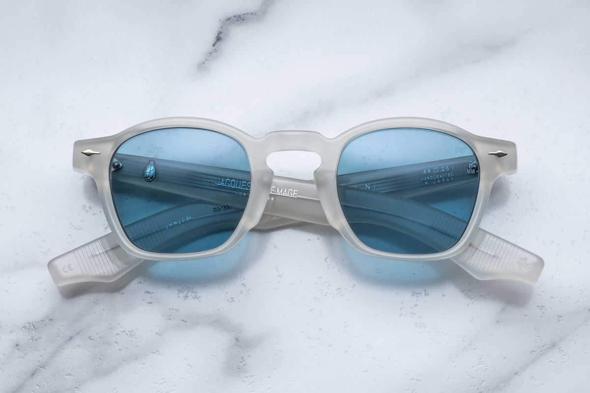 Jacques Marie Mage Zephirin Dune sunglasses with rounded frames and tinted lenses, close-up front view.