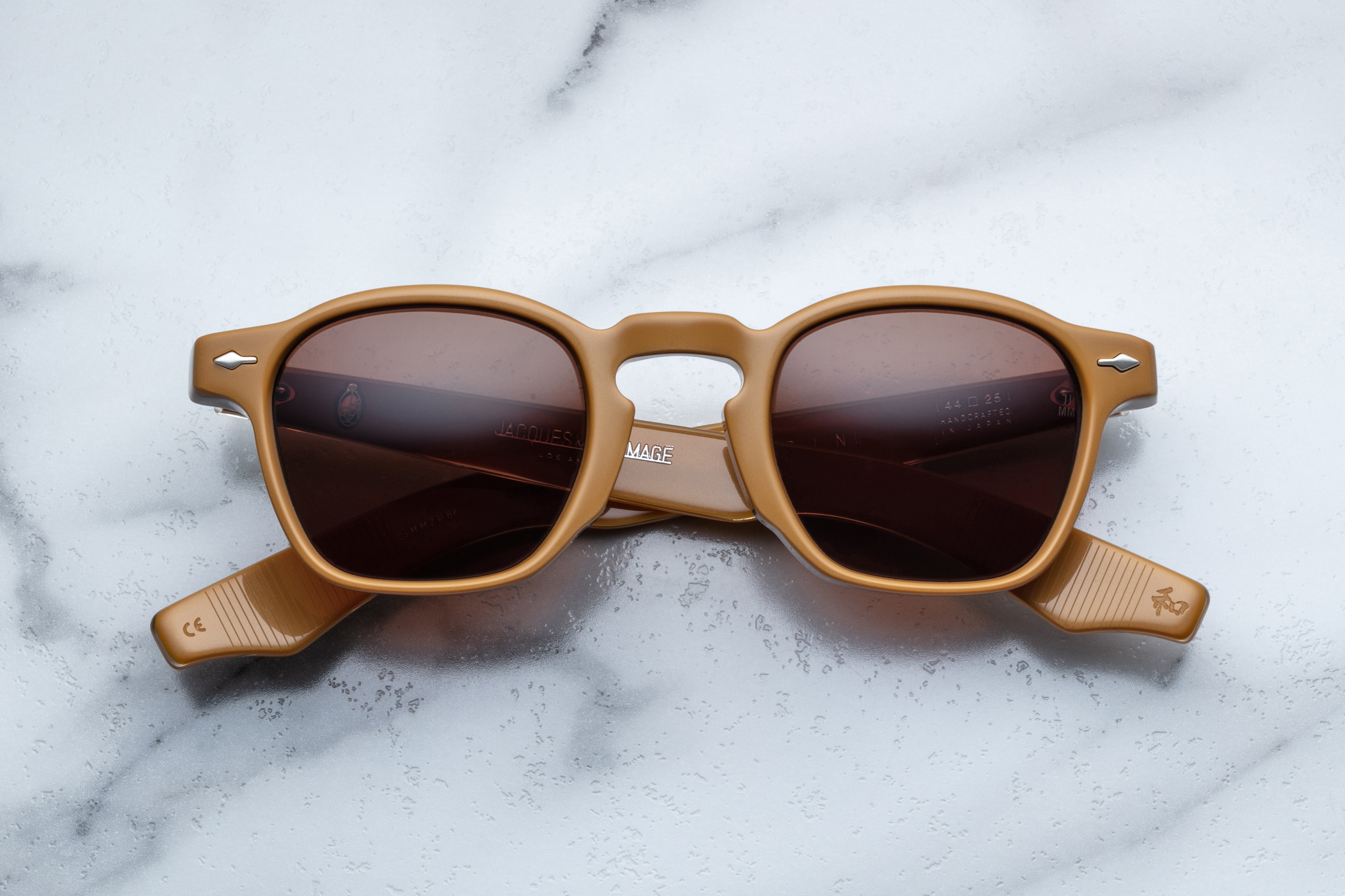 Jacques Marie Mage Zephirin sunglasses with tan frames and clear lenses, front view showing stylish design and craftsmanship.