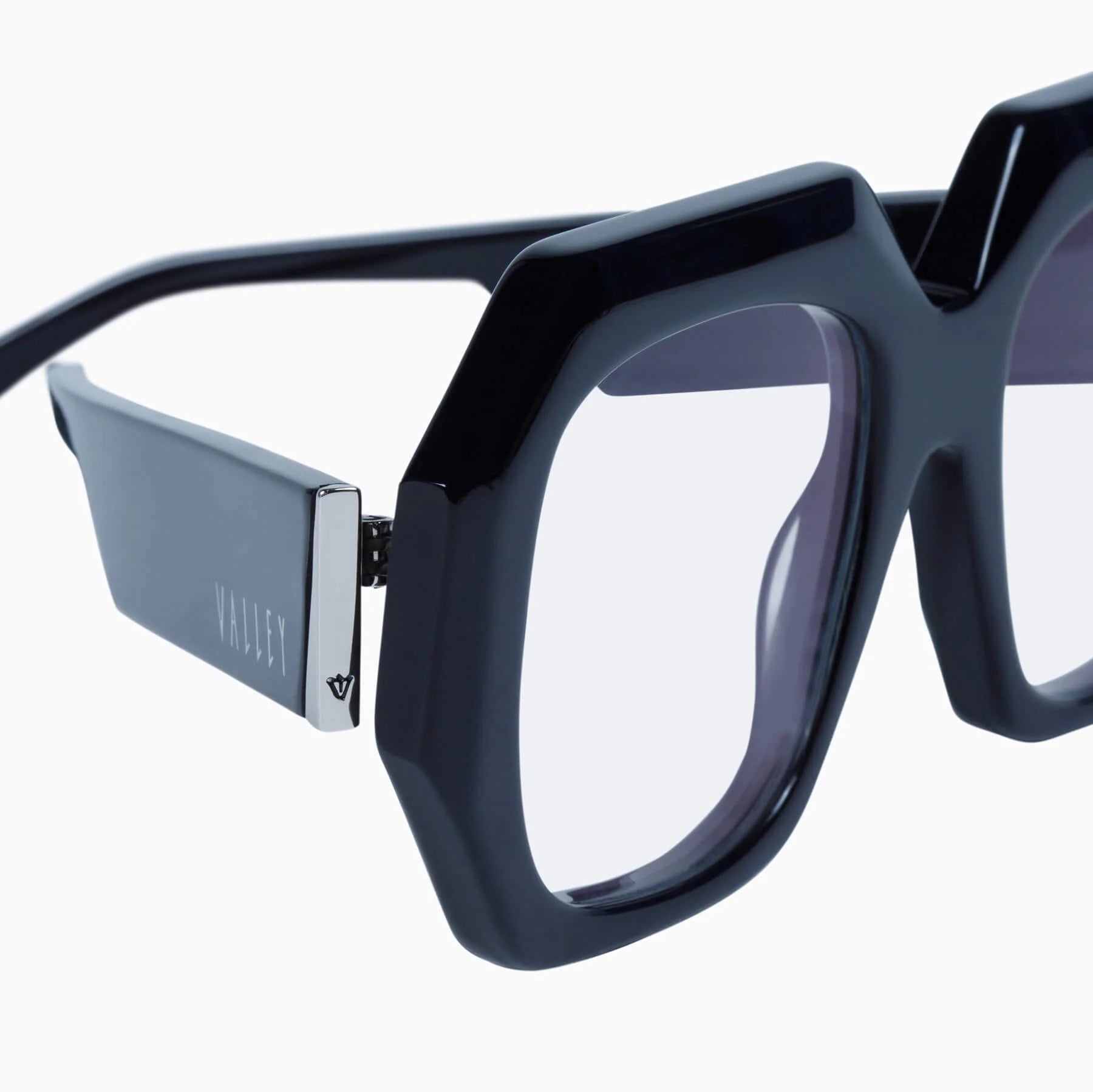 Valley Eyewear Monolith sunglasses with glossy black frames and clear lenses, stylish and modern design.