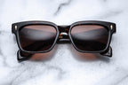 Jacques Marie Mage Molino 55 sunglasses with dark tinted lenses and stylish frame, close-up view of the eyewear.