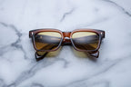 Jacques Marie Mage Molino 55 sunglasses with hickory-colored frames and clear lenses, front view showing stylish design.