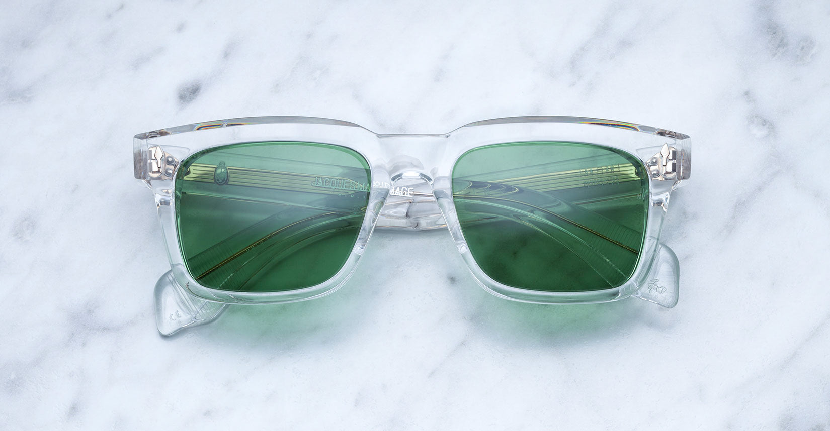Jacques Marie Mage Torino sunglasses with clear frame and tinted lenses, front view showcasing stylish eyewear design.