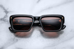 Jacques Marie Mage Walker Eclipse sunglasses with round black frames and dark tinted lenses, front view.