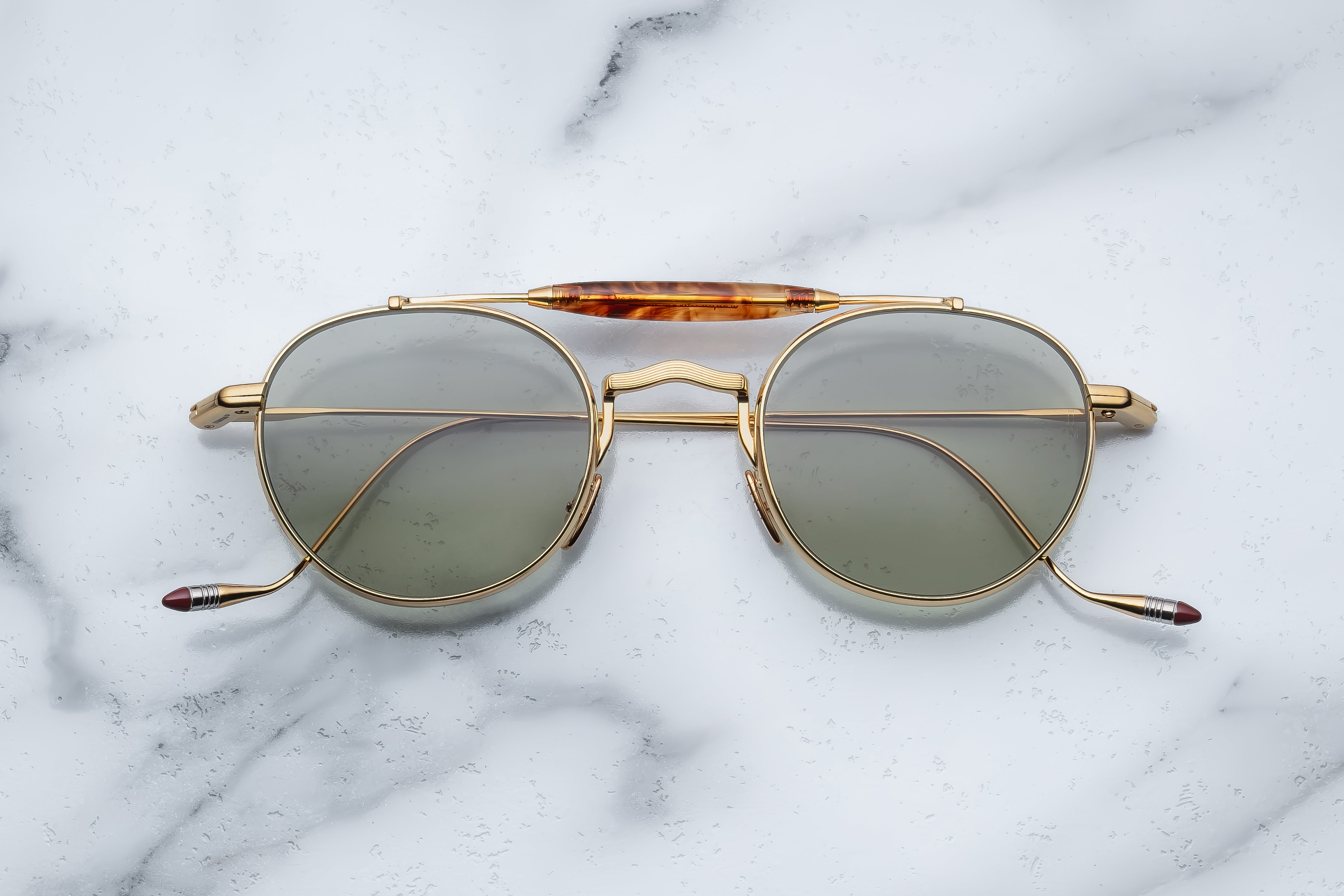 Jacques Marie Mage Dasan Geneva sunglasses with sleek black frames and tinted lenses, front view showing stylish design.