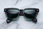 Jacques Marie Mage Molino 55 sunglasses with black fade frames and clear lenses, front view showing stylish design.