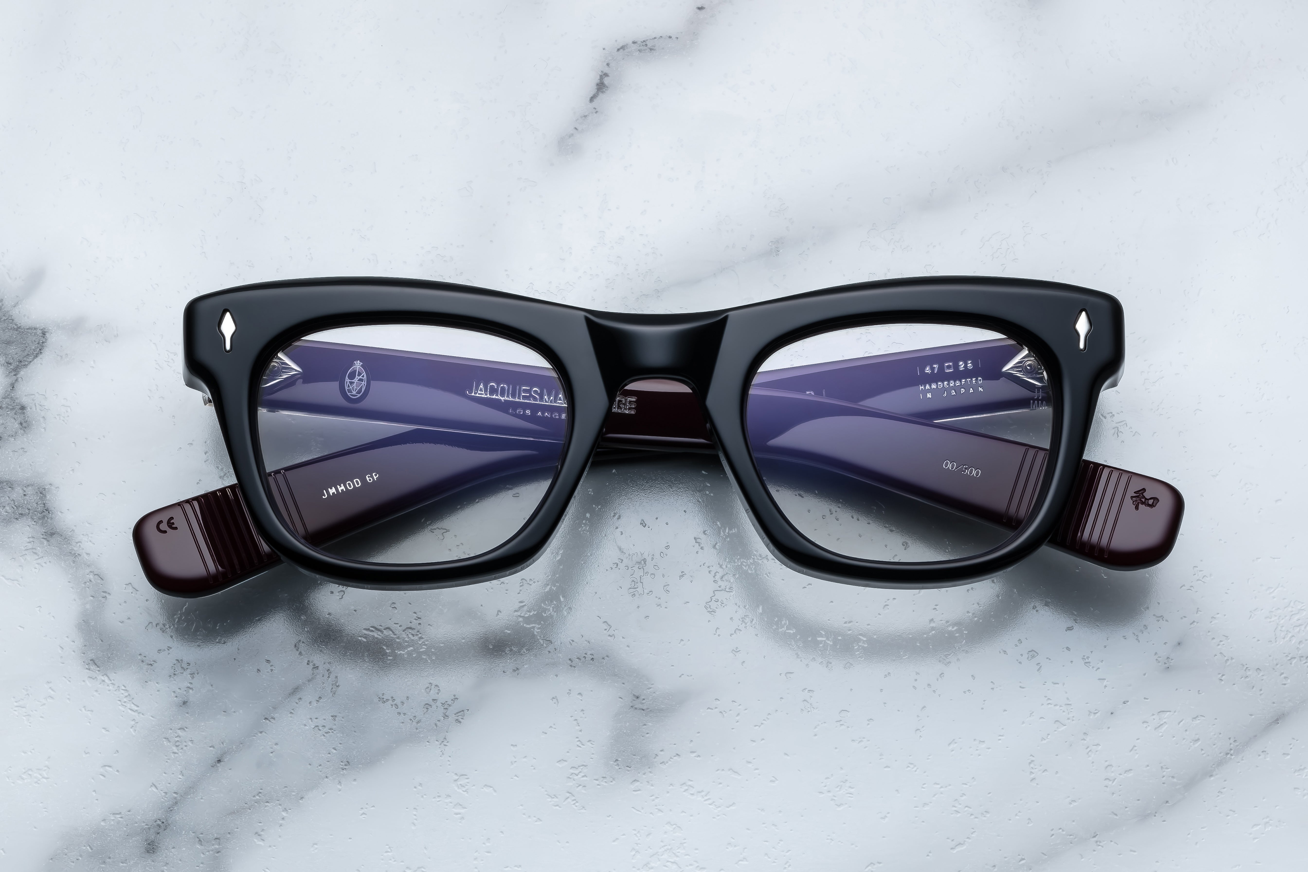 Jacques Marie Mage Godard Bloodstone optical glasses with round frames and tortoise-patterned temples, front view.