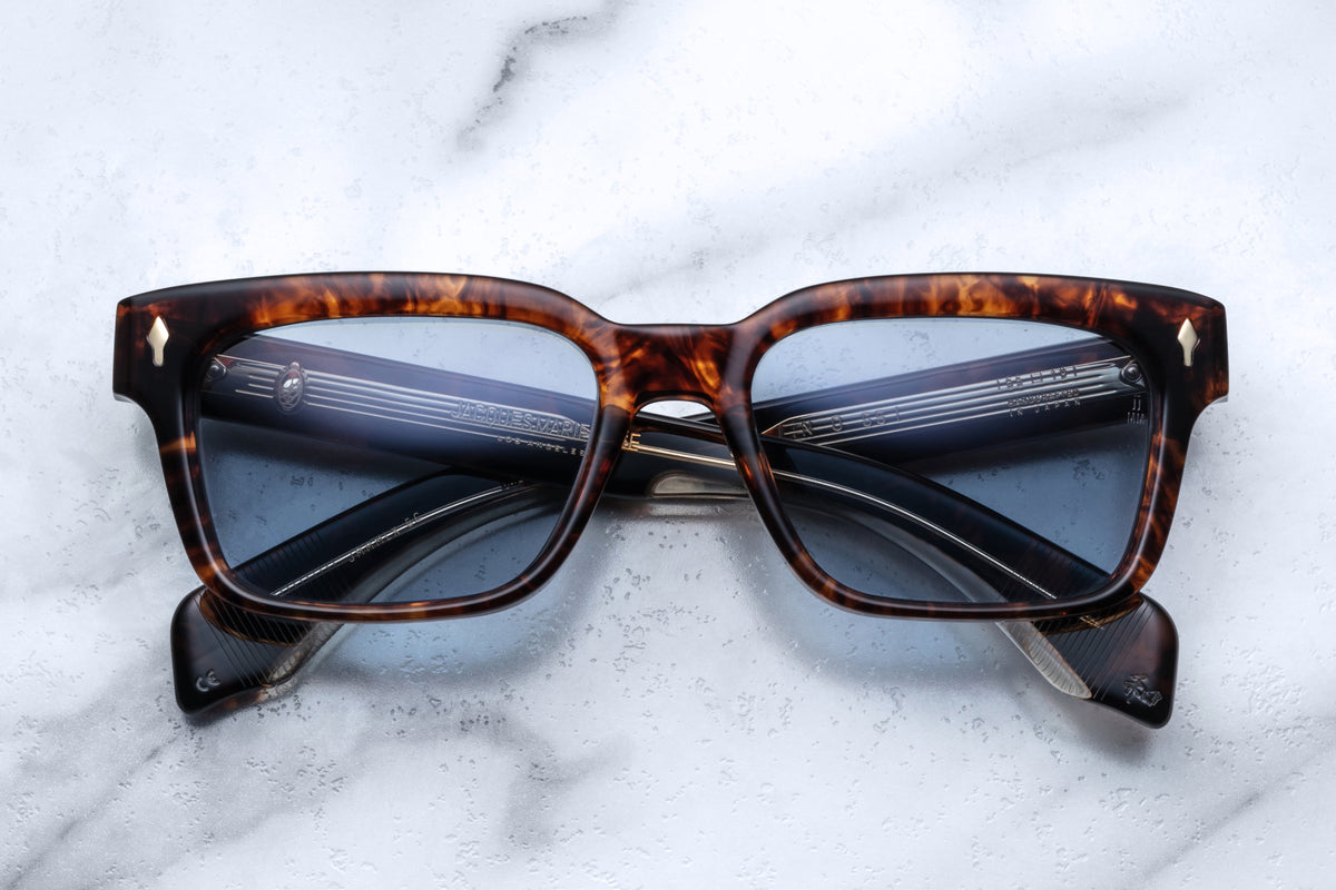 Jacques Marie Mage Molino 55 sunglasses with argyle patterned frames and clear lenses, front view showing stylish design.