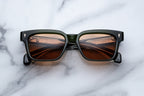 Jacques Marie Mage Molino 55 sunglasses with round Borneo-colored frames and clear lenses, front view.