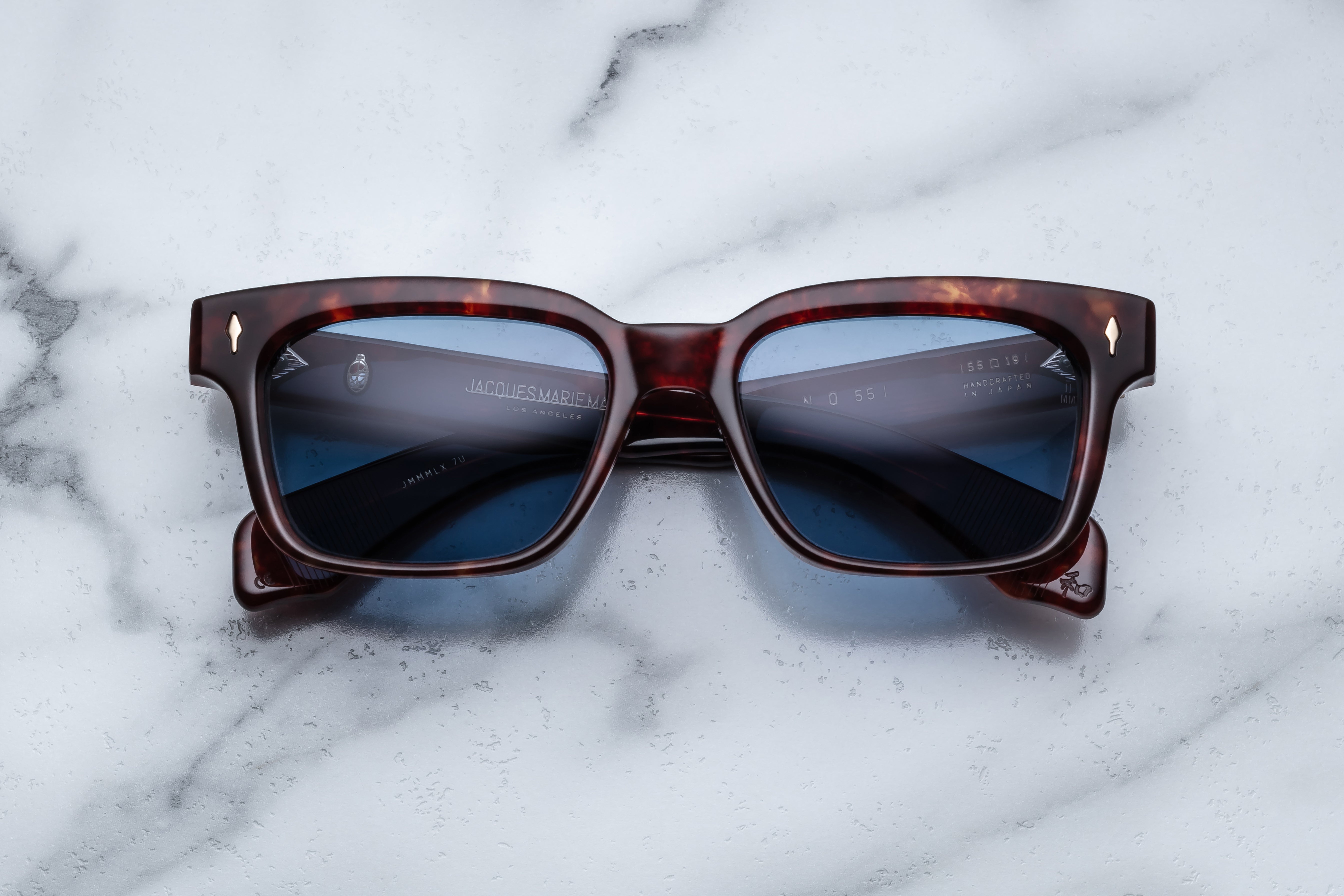 Jacques Marie Mage Molino 55 sunglasses with breccia-style frames and tinted lenses, shown from the front.
