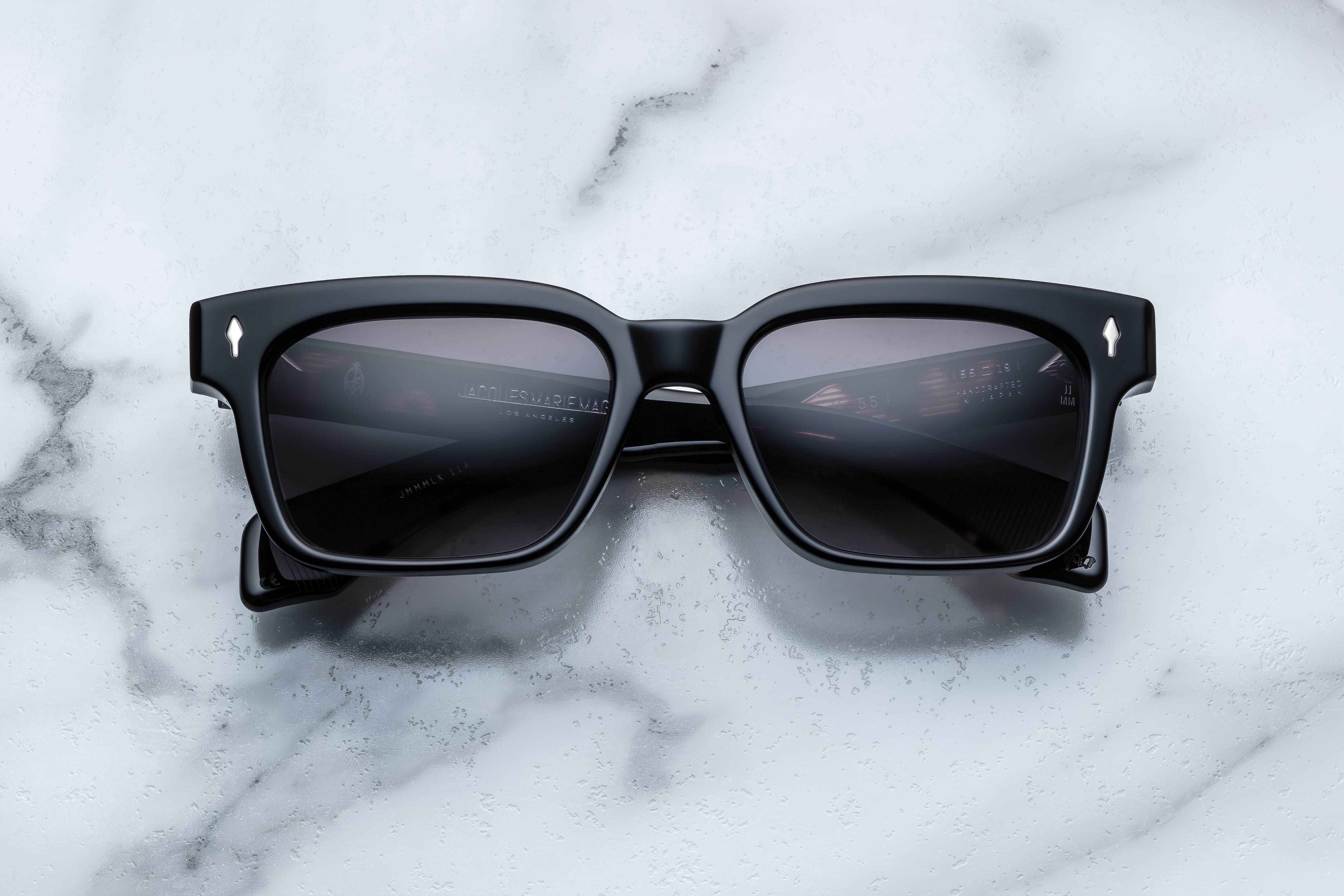 Jacques Marie Mage Molino 55 sunglasses with black frame and sleek design, front view showing lens and stylish details.