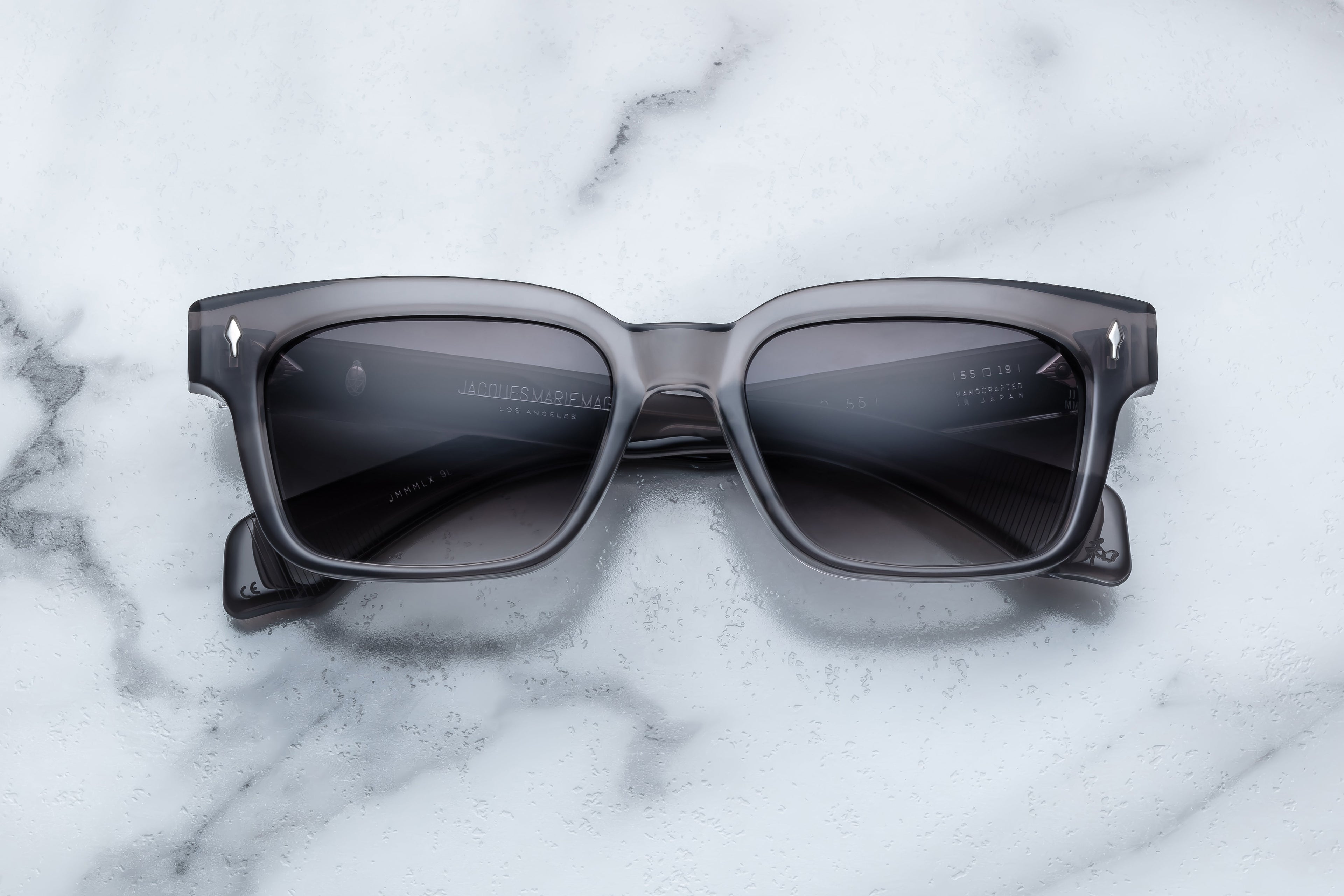 Jacques Marie Mage Molino 55 sunglasses showing the front view with sleek black frames and tinted lenses.
