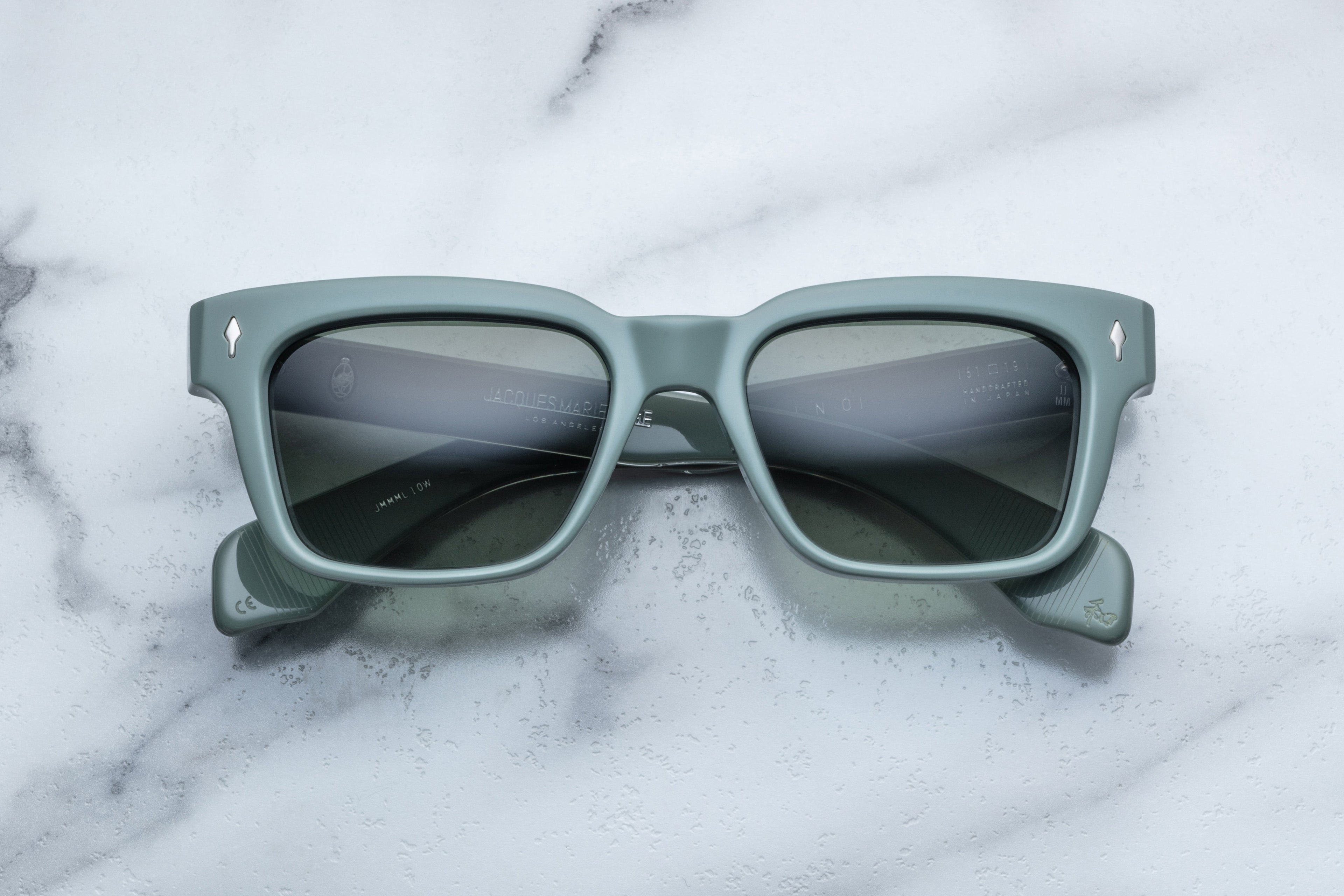 Jacques Marie Mage Molino sunglasses with a sleek, modern frame and tinted lenses, front view on a white background