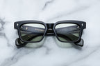 Jacques Marie Mage Molino Cobra sunglasses with round black frames and clear lenses, front view showing detailed design