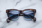 Jacques Marie Mage Molino Havana sunglasses with round frames and tortoiseshell pattern, front view.