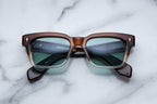 Jacques Marie Mage Molino sunglasses with hickory fade frames and clear lenses, front view showing stylish design.