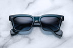 Jacques Marie Mage Molino Indigo sunglasses with rounded frames and dark lenses, front view showing stylish design.