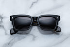 Jacques Marie Mage Molino noir sunglasses with black frames and clear lenses, front view showing sleek design and modern style.