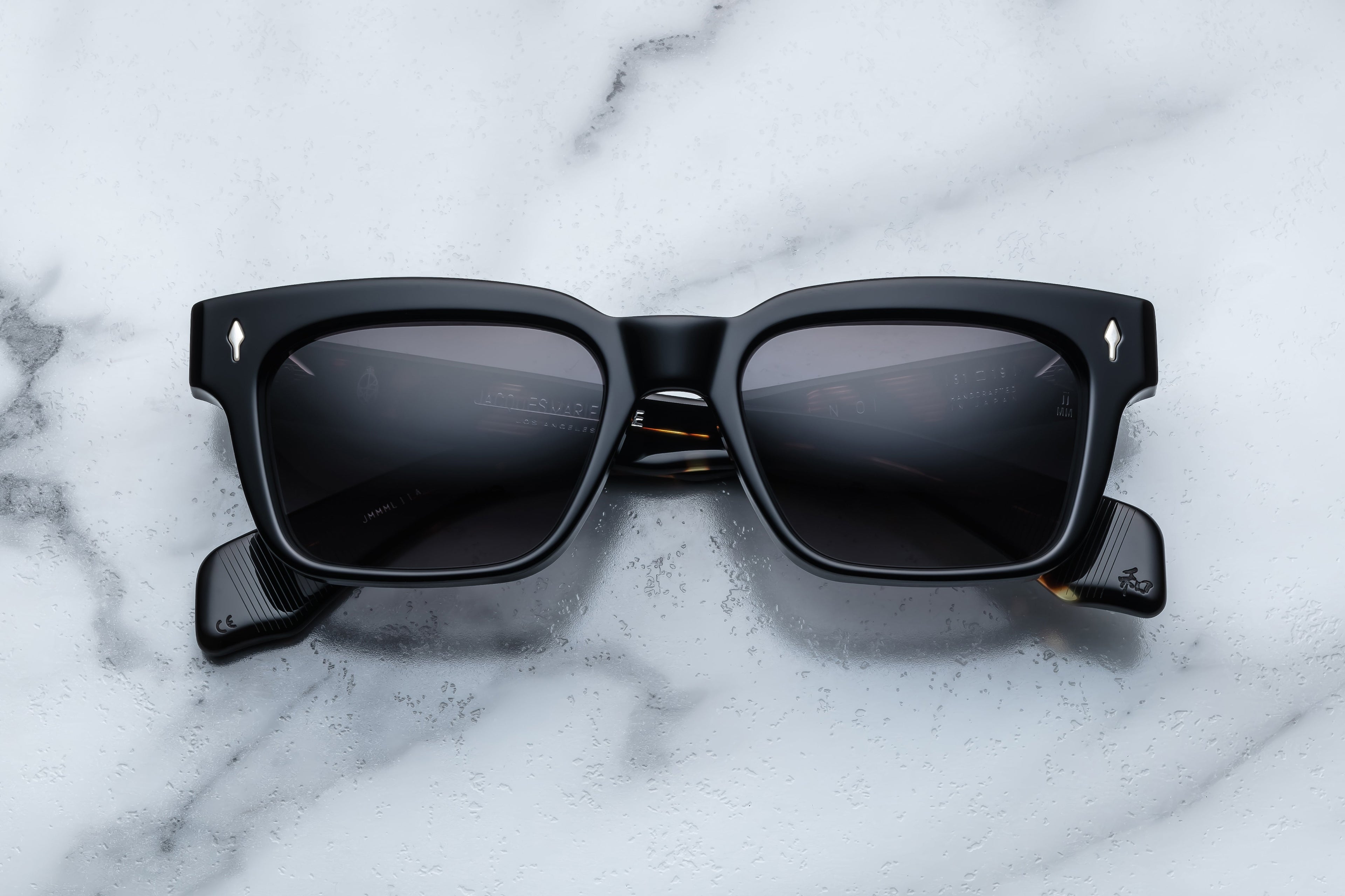Jacques Marie Mage Molino noir sunglasses with black frames and clear lenses, front view showing sleek design and modern style.