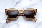 Jacques Marie Mage Molino sunglasses with ocre-colored frames and clear lenses, front view showing stylish design.