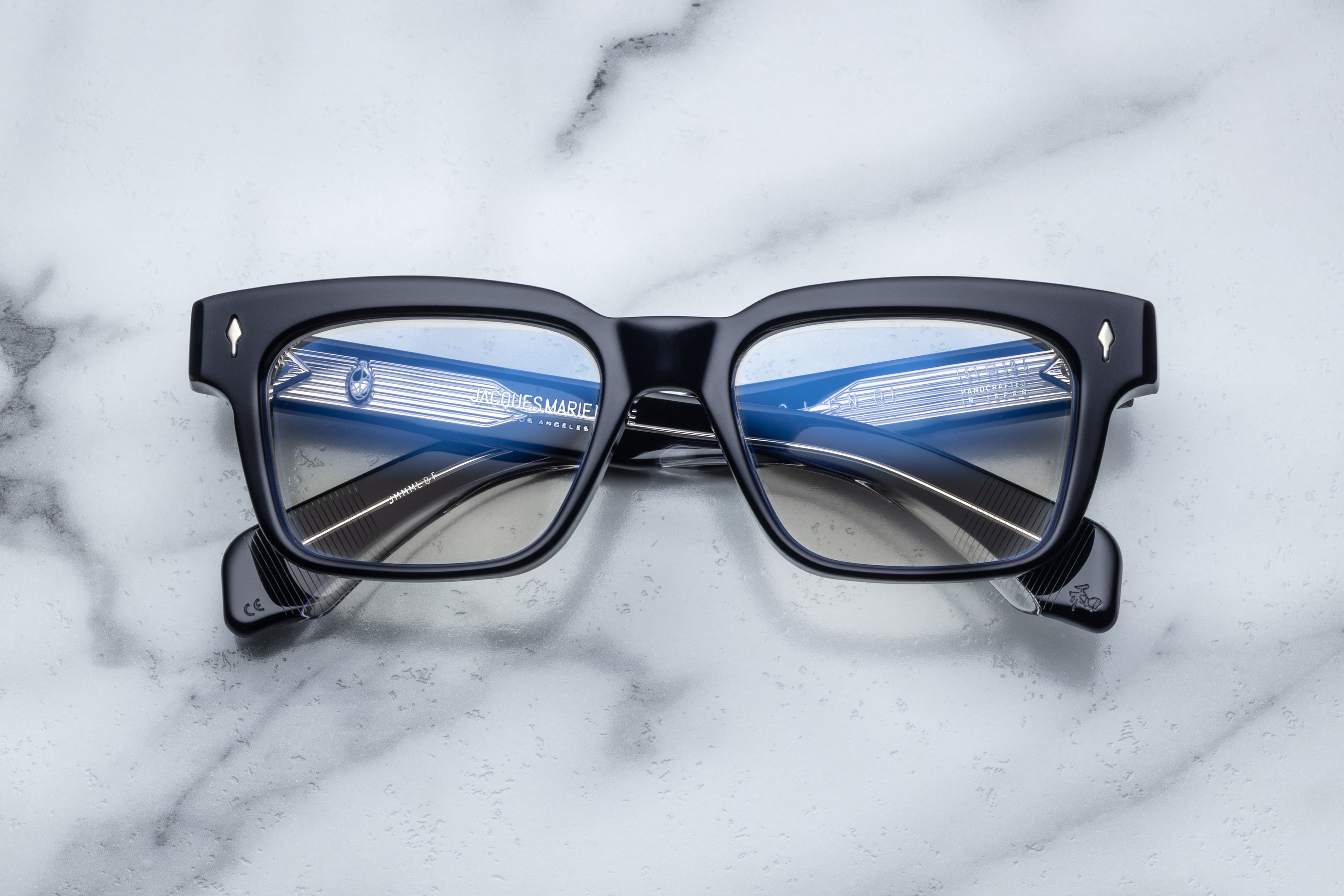 Optical Molino sunglasses by Jacques Marie Mage with clear frames and stylish design, front view of the eyewear.