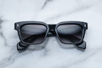 Jacques Marie Mage Molino slate sunglasses with rounded frames and clear lenses, displayed front view.
