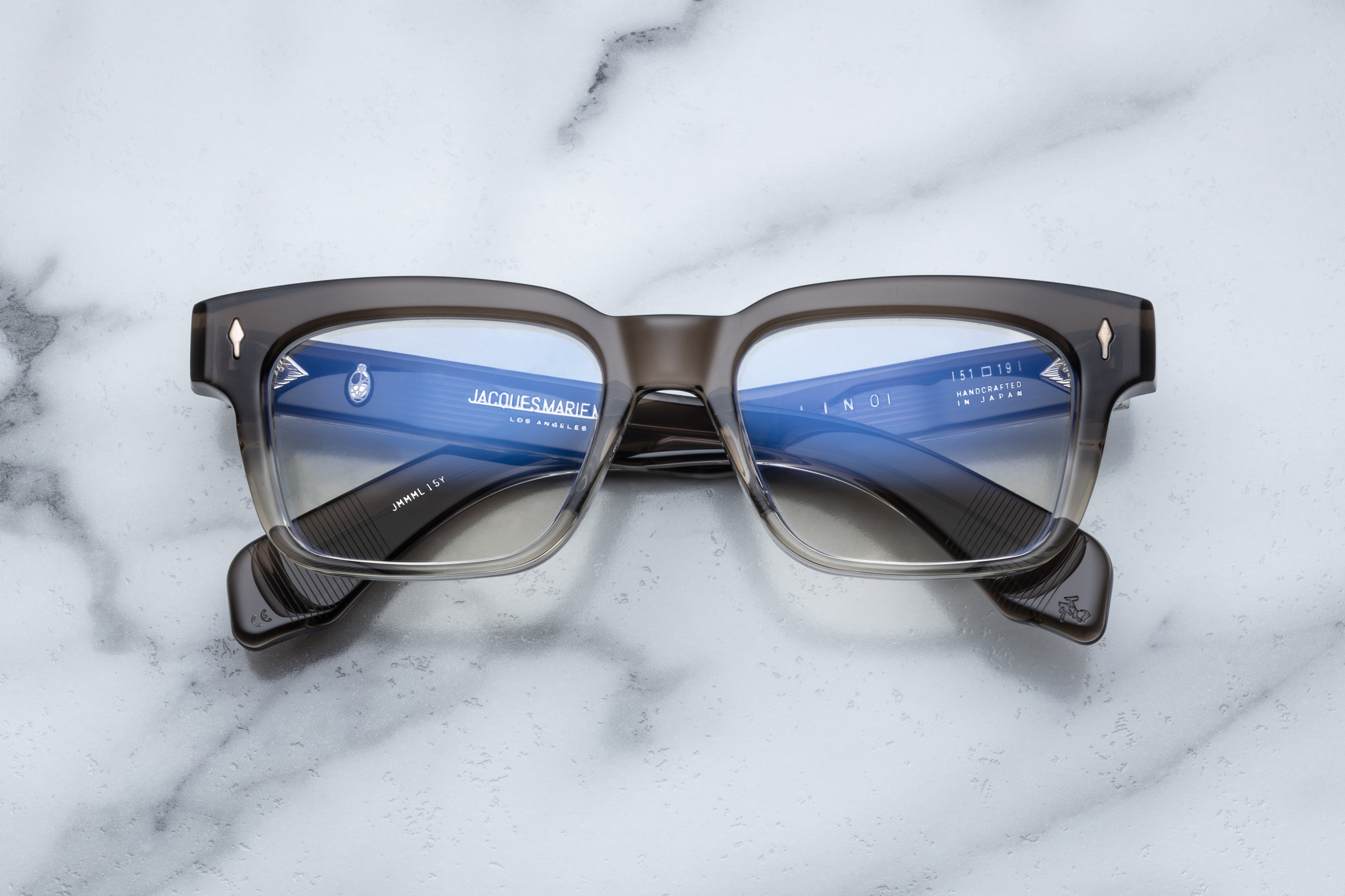 Jacques Marie Mage Molino Smoke Fade optical glasses with rounded black frames and clear lenses, front view.