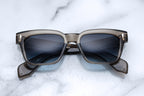 Jacques Marie Mage Molino taupe sunglasses front view with sleek, rounded frames and tinted lenses.